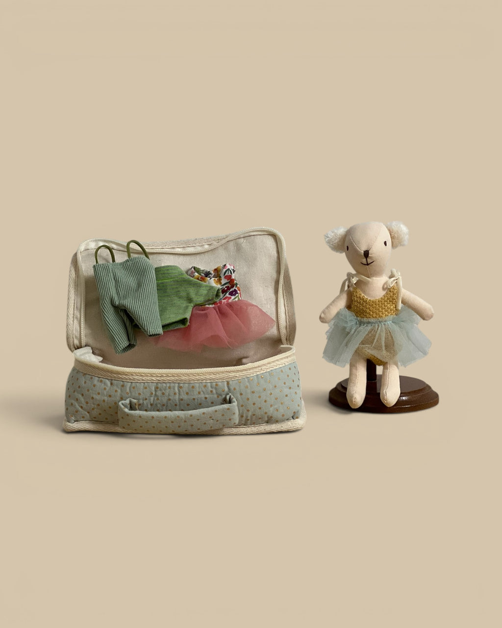 Homestyle Collective fabric suitcase playset with a stuffed bear doll, tiny outfits, and a miniature sleeping bag.