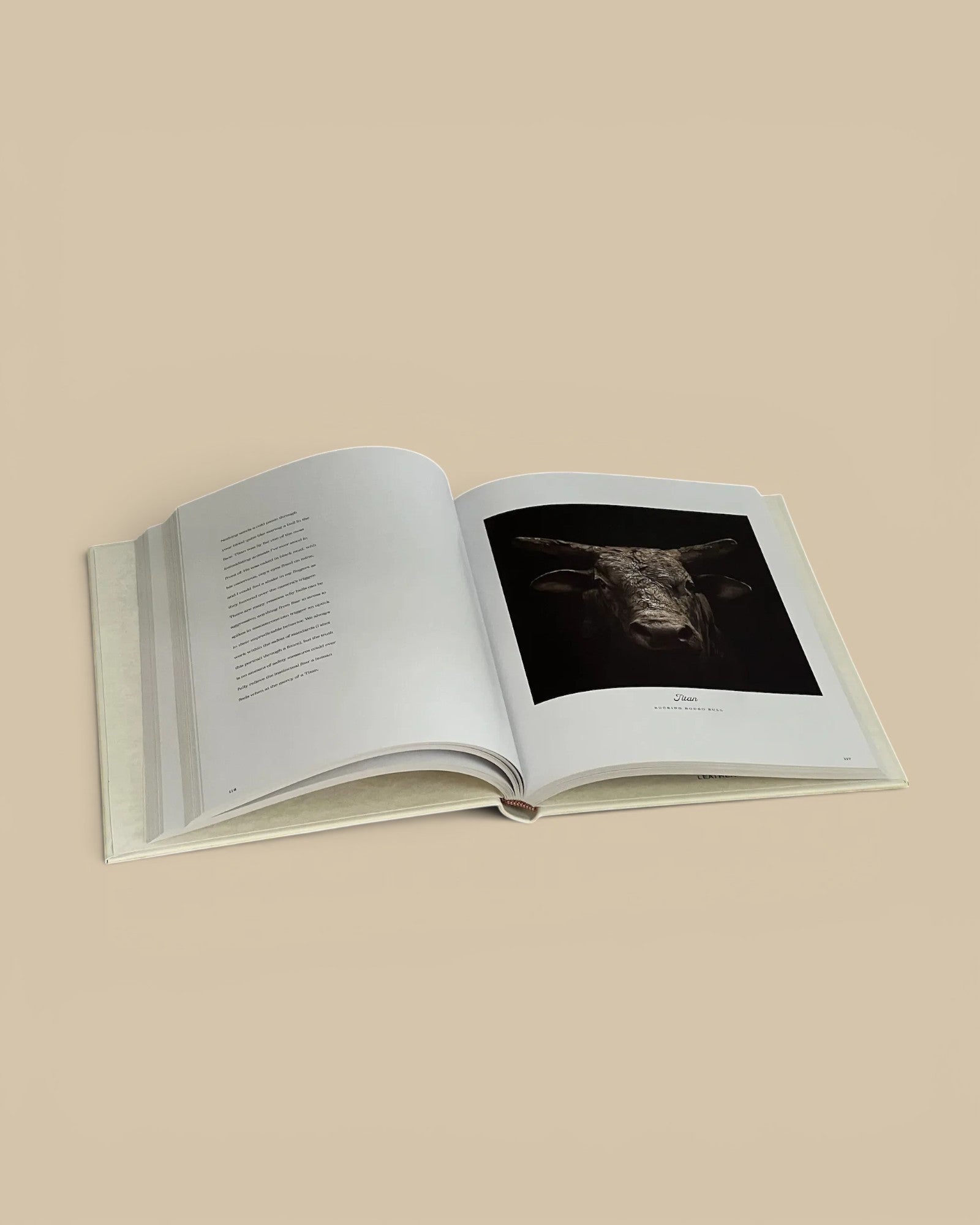 Homestyle Collective Farm Life leather-bound book open to a black and white portrait of a bull on a rustic table