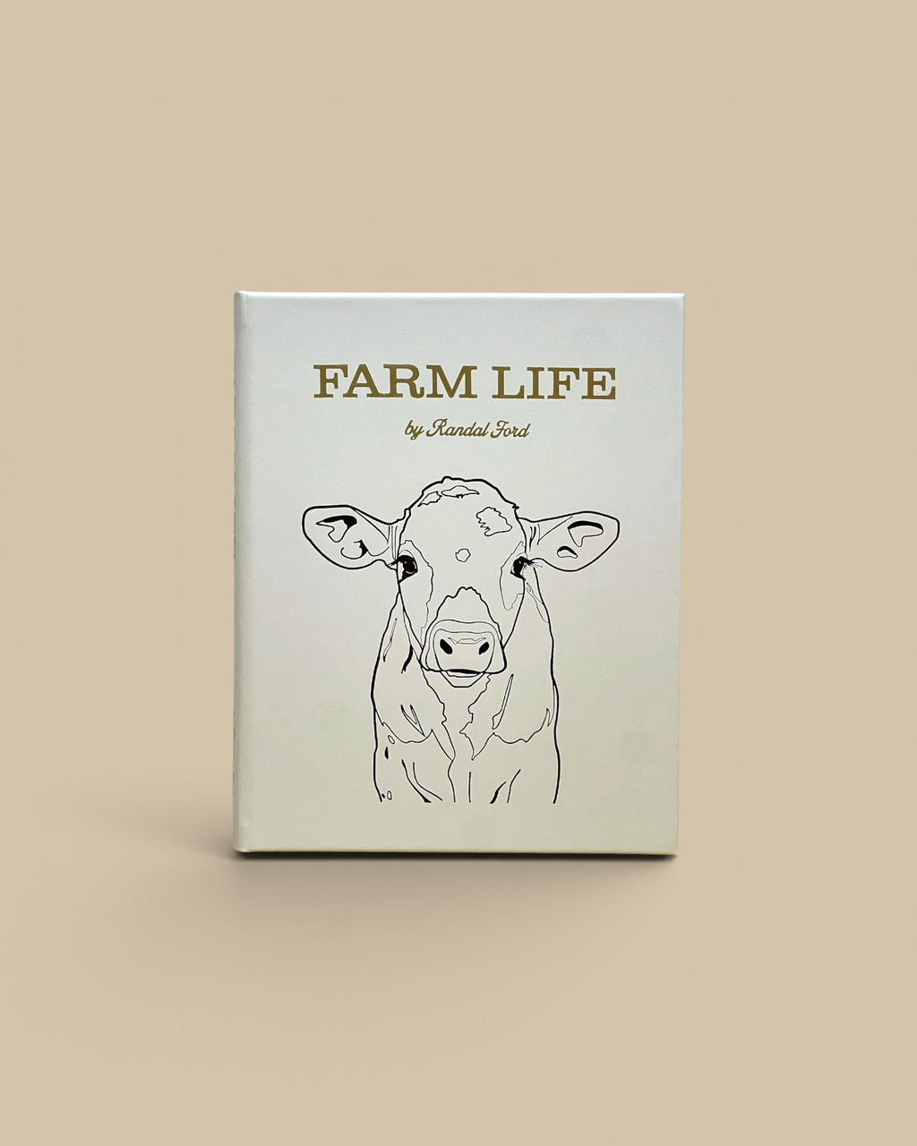 Homestyle Collective Farm Life leather-bound book featuring a minimalist line art cow portrait on a white cover.
