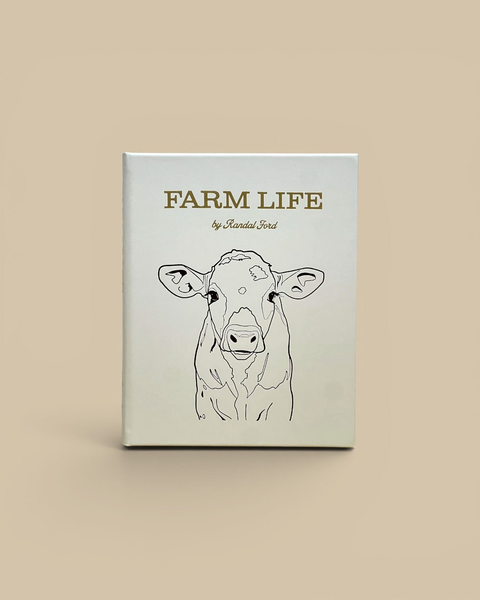 Homestyle Collective Farm Life leather-bound book featuring a minimalist line art cow portrait on a white cover.