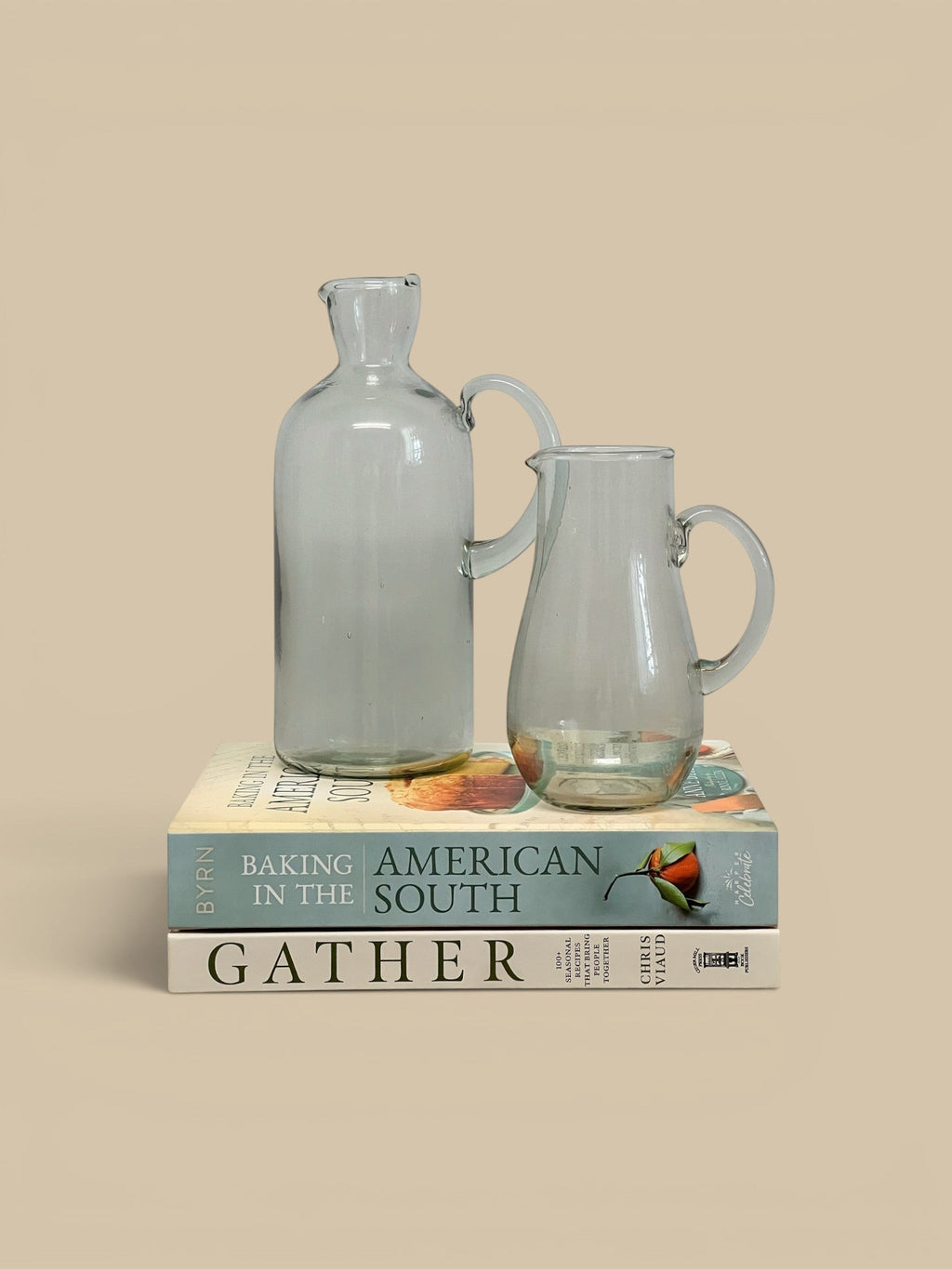 Homestyle Collective Ferra glass pitcher with handle and spout, clear, handcrafted artisanal detail, sculptural silhouette.