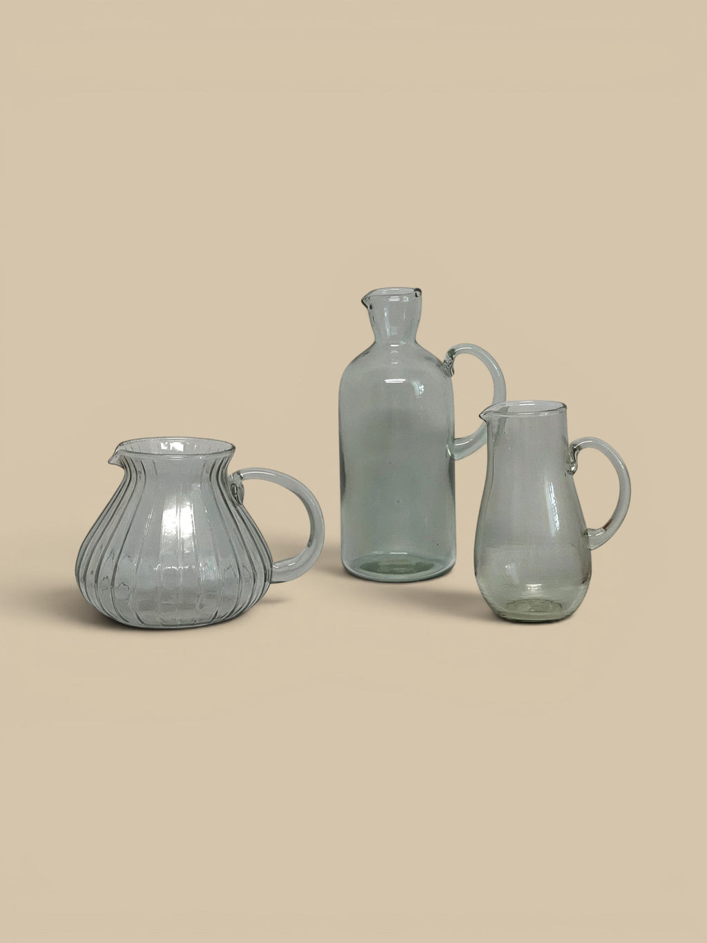 Homestyle Collective Ferra glass pitcher with ribbed texture and handle, clear glass.