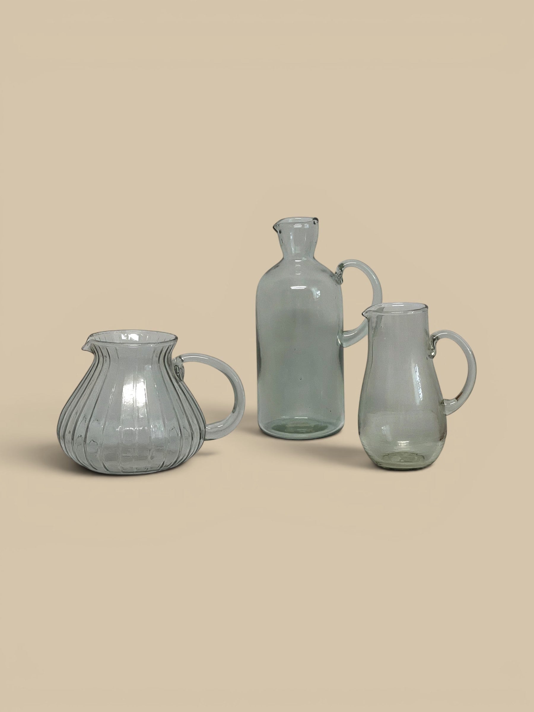 Homestyle Collective Ferra glass pitcher with ribbed texture and handle, clear glass.