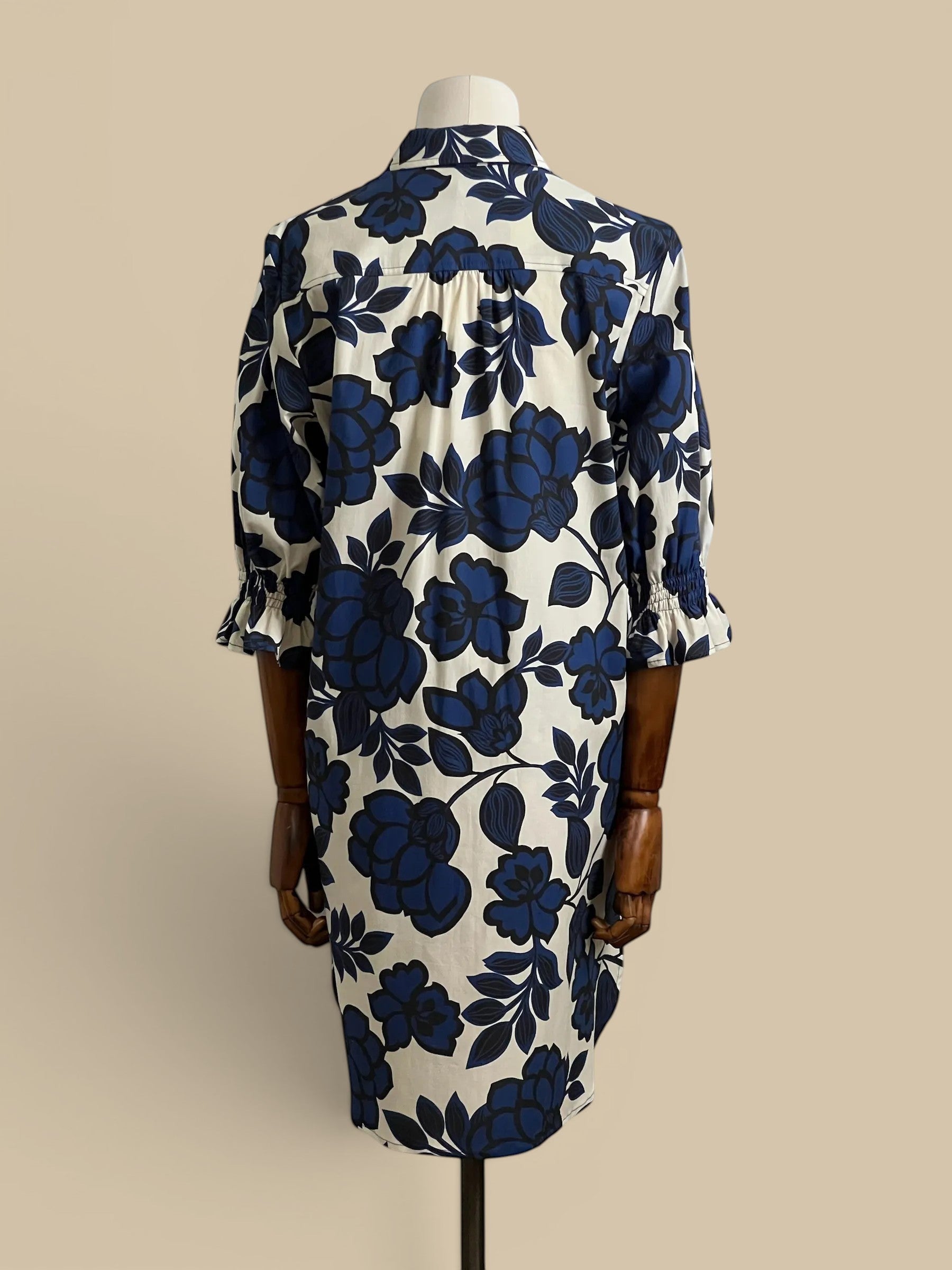 Homestyle Collective Finley Miller dress, navy, white, and black floral print, puff sleeves, button front, knee-length shirt dress.