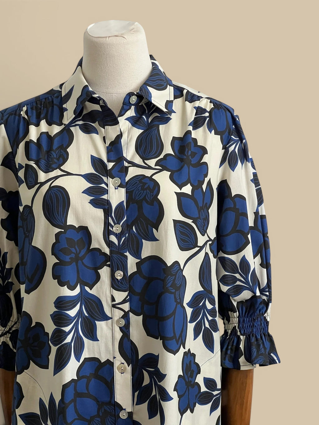 Homestyle Collective Finley Miller navy, white, and black floral print cotton blend shirt dress with puff sleeves and button front.