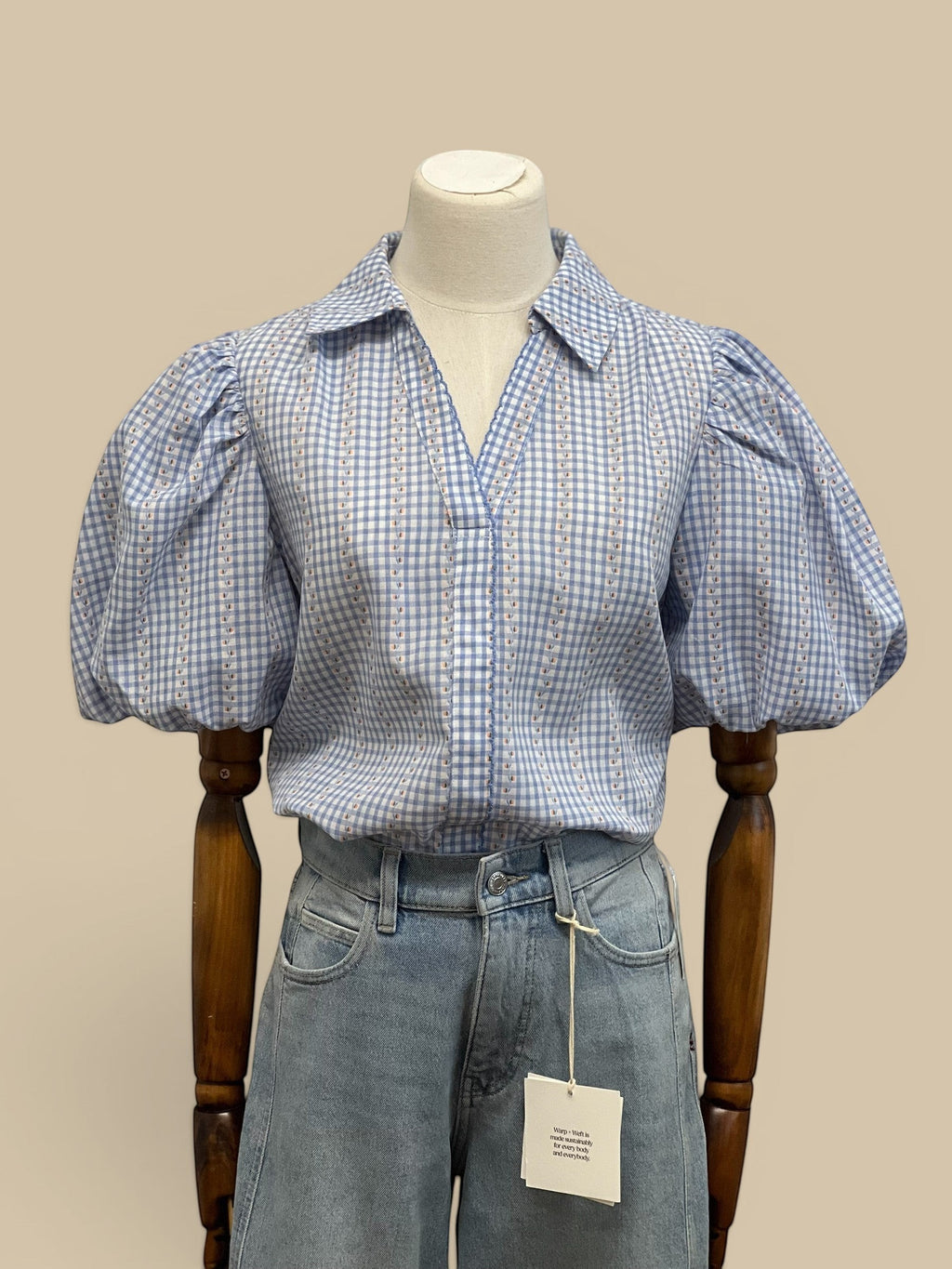Homestyle Collective blue and white gingham blouse with puff sleeves and floral embroidery. Collared neckline.