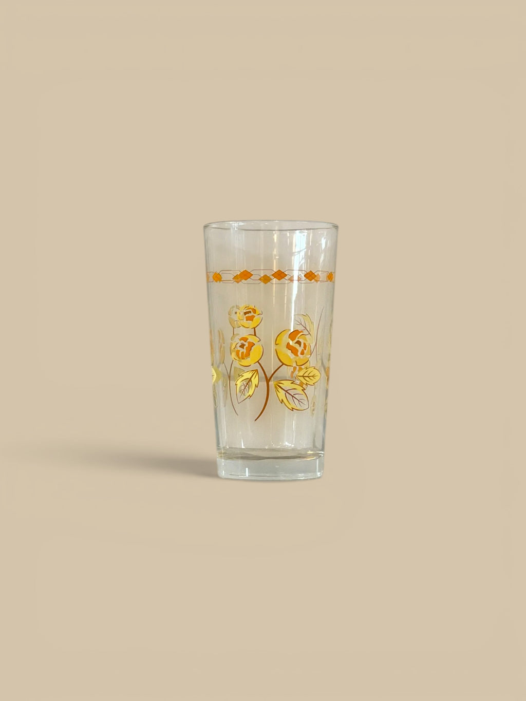 Homestyle Collective set of 2 clear glass tumblers with blue thistle and yellow rose floral designs.