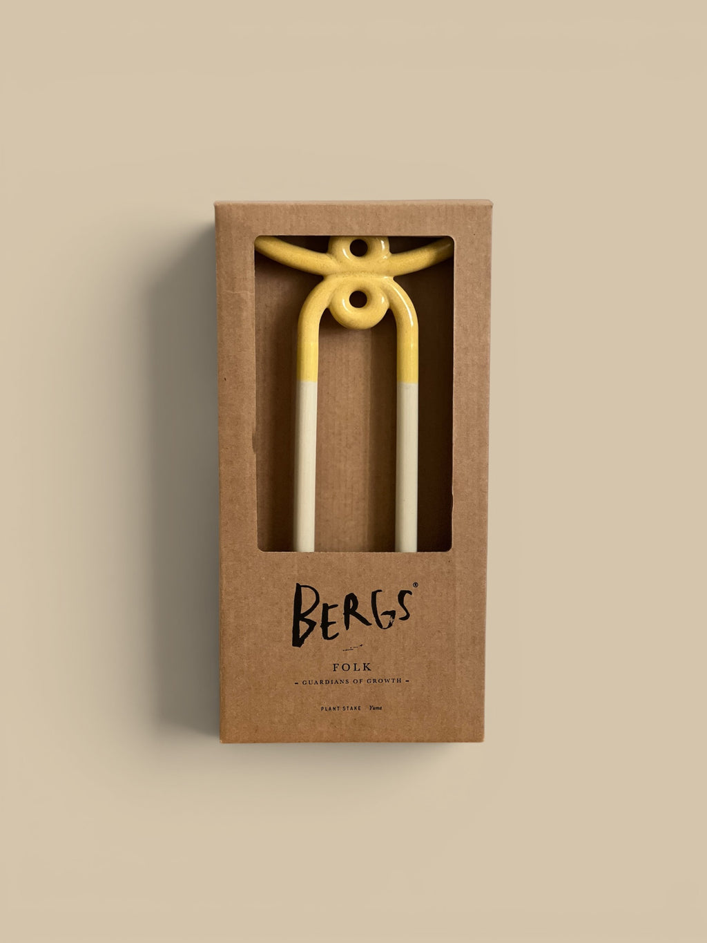 Homestyle Collective Folk plant stake in pale yellow and white ceramic, shaped like a figure with abstract arms and two legs.