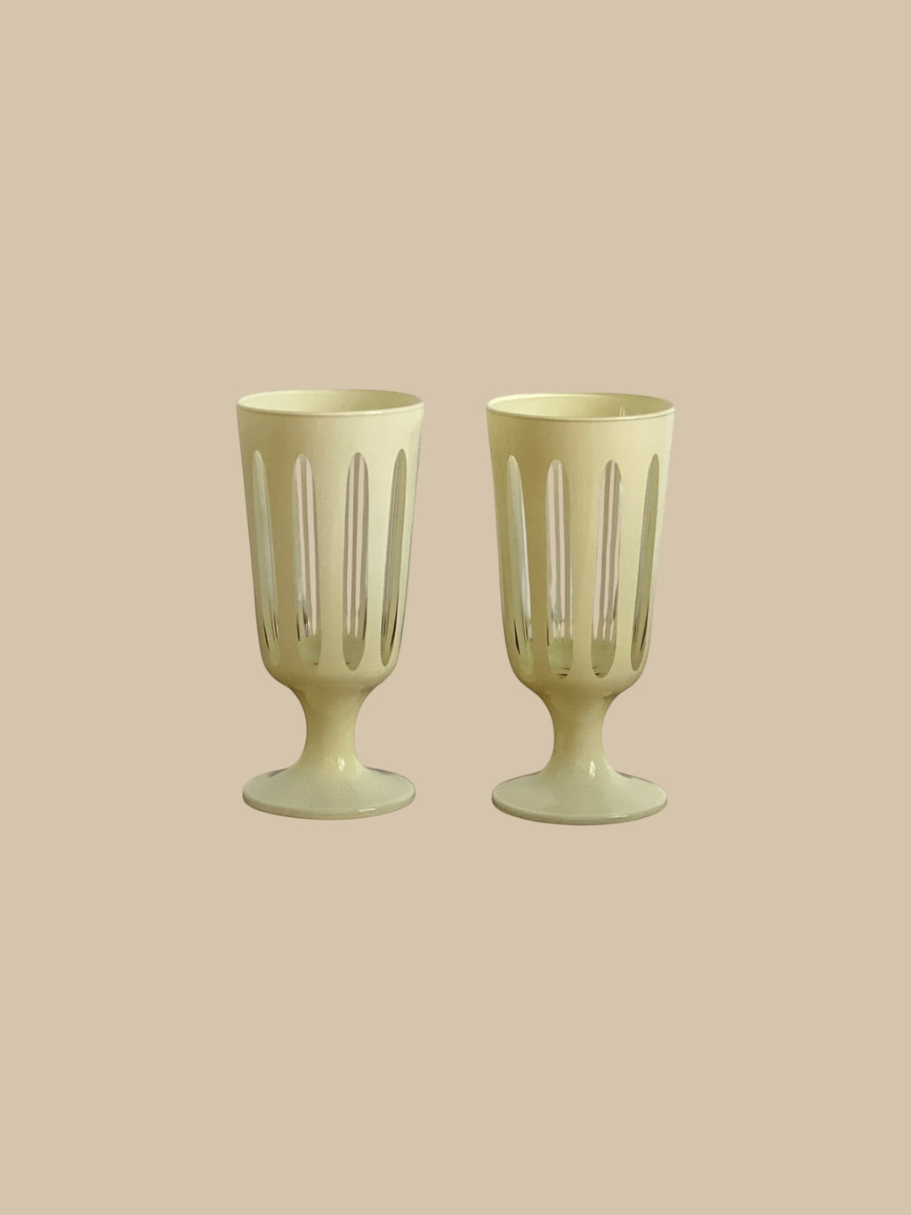 Homestyle Collective Empire Footed Ale Set of 2 glasses in powder white with cut-out details and a footed base.