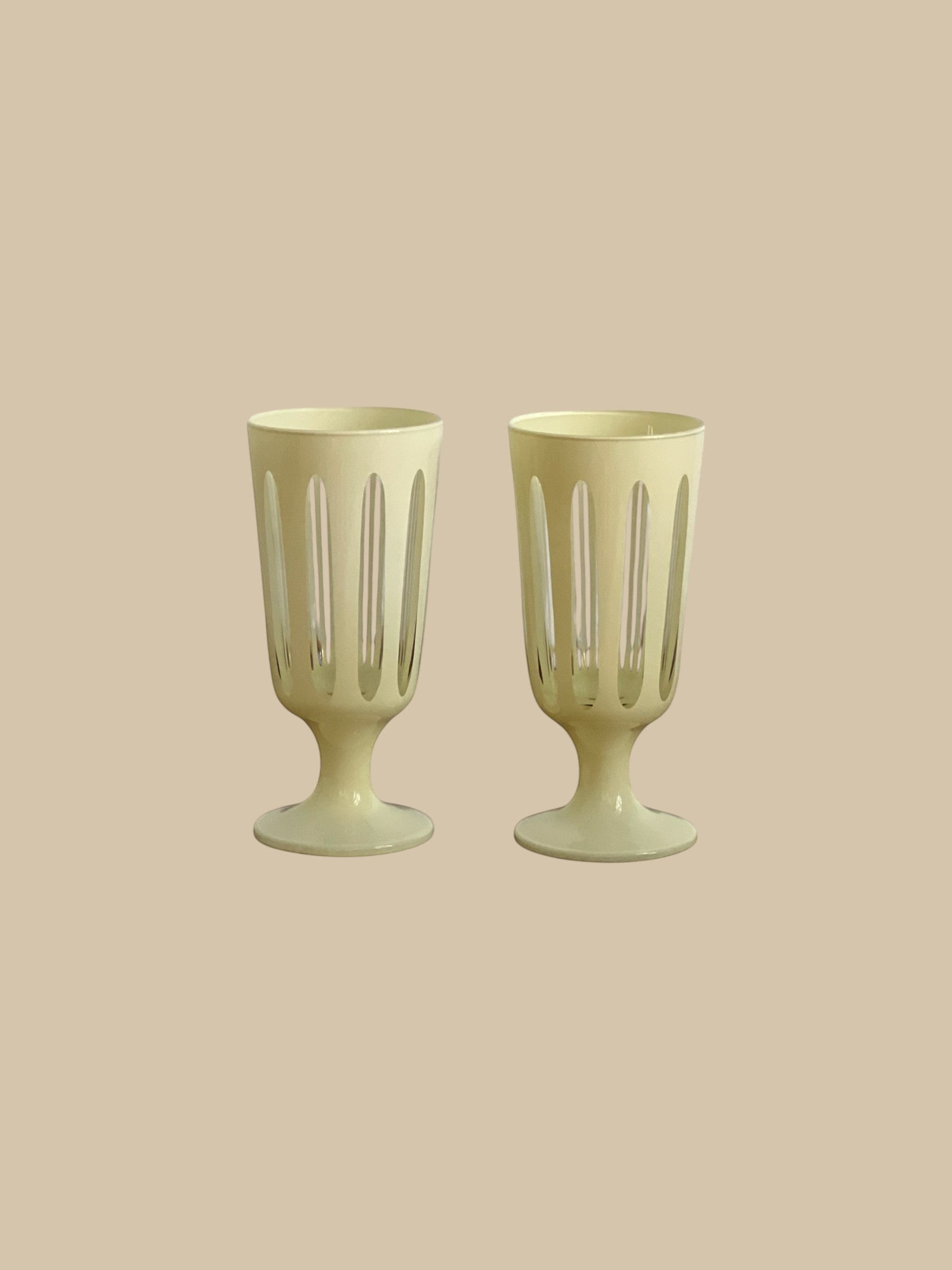 Homestyle Collective Empire Footed Ale Set of 2 glasses in powder white with cut-out details and a footed base.