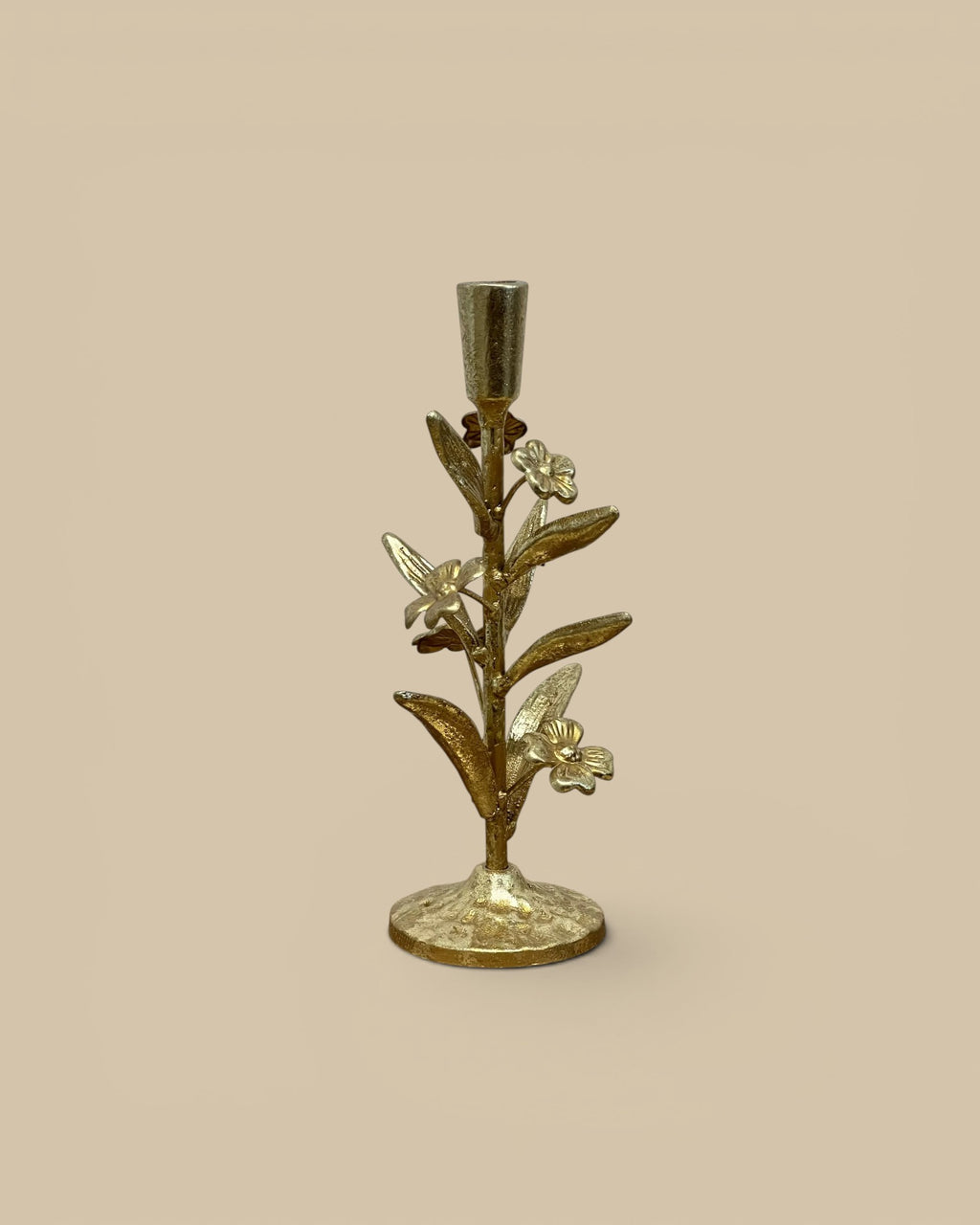 Homestyle Collective gilded floral candle holder with a textured gold finish and intricate leaf and flower details.