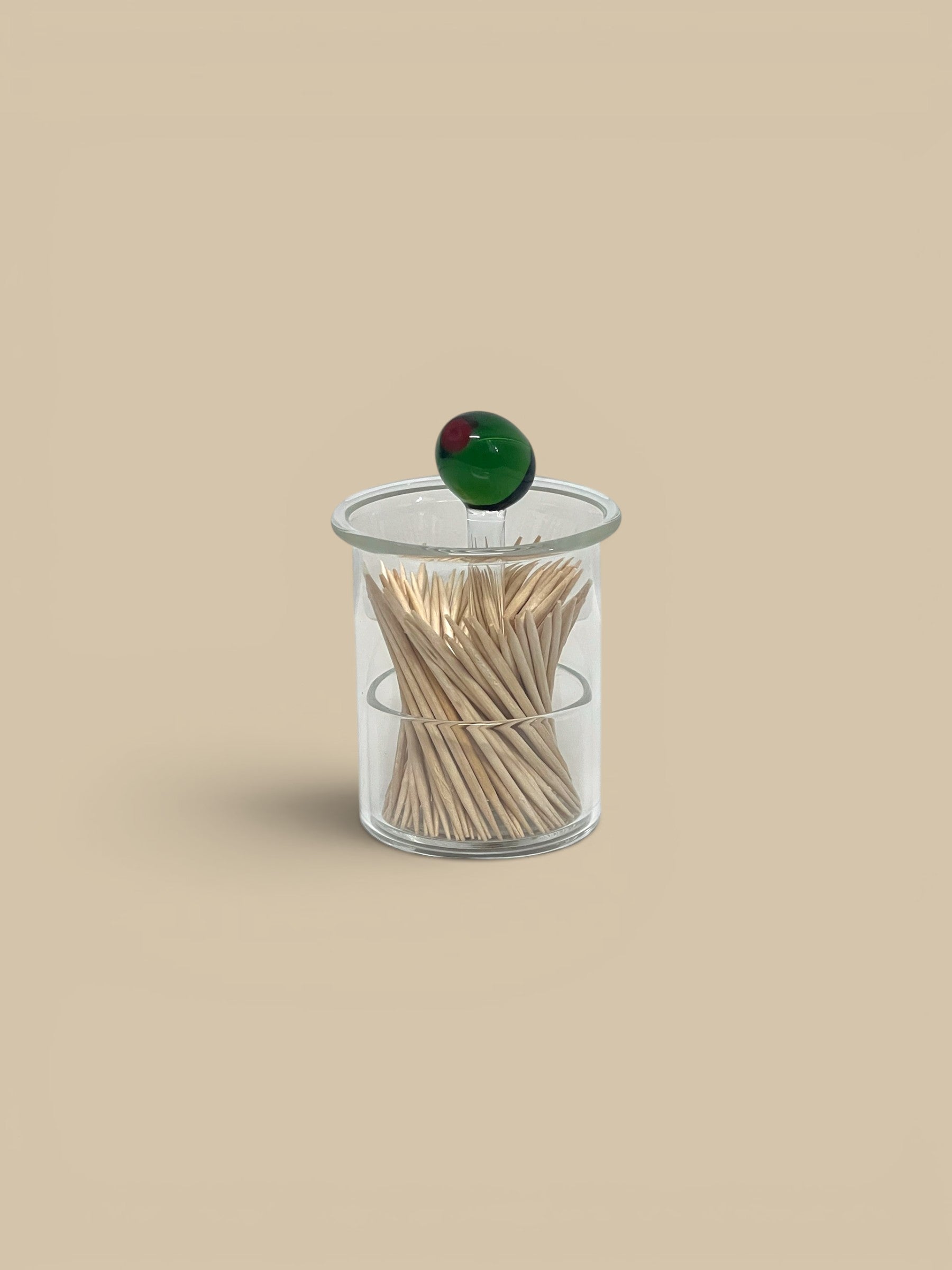 Homestyle Collective clear hand-blown glass toothpick holder with a green glass olive topper.