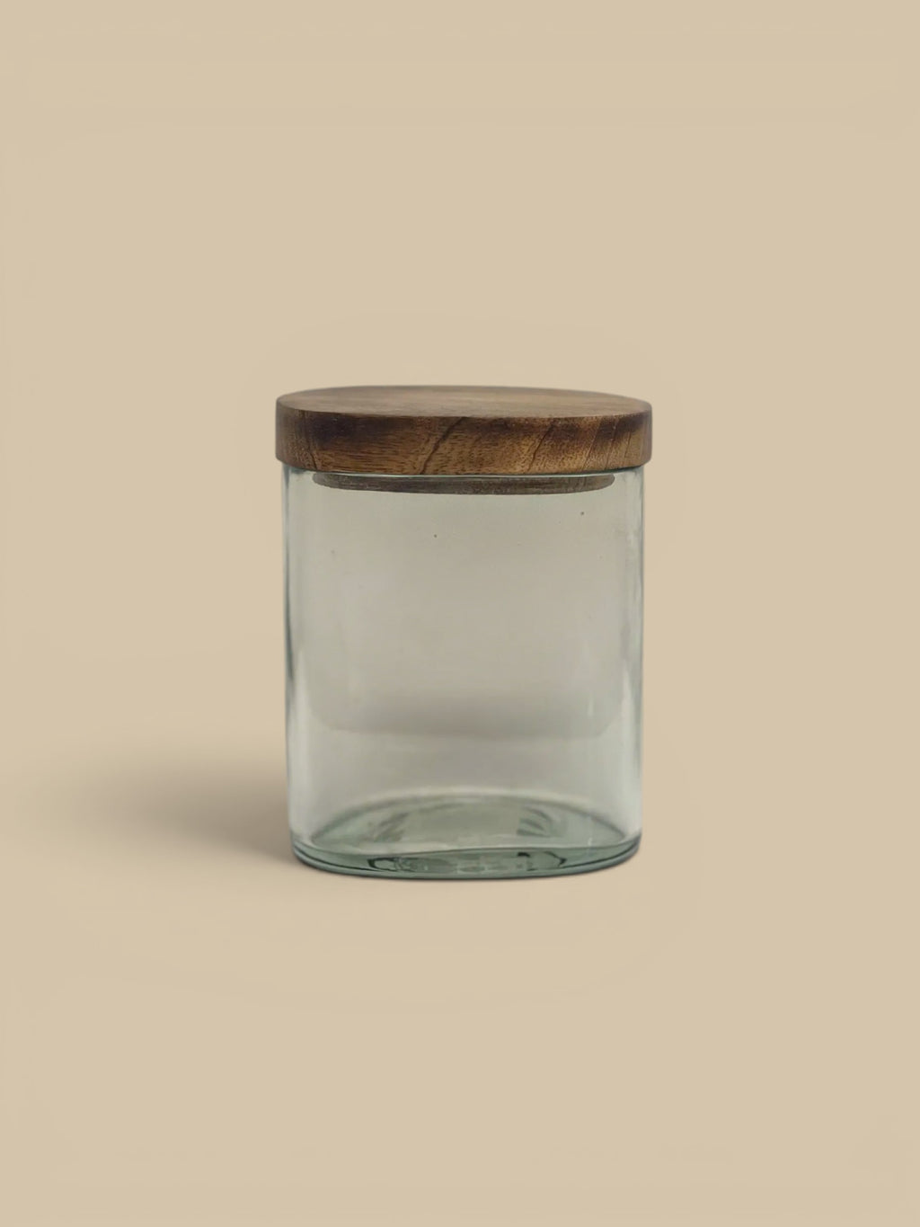 Homestyle Collective clear glass storage jar with a natural wood lid, perfect for pantry or countertop organization.