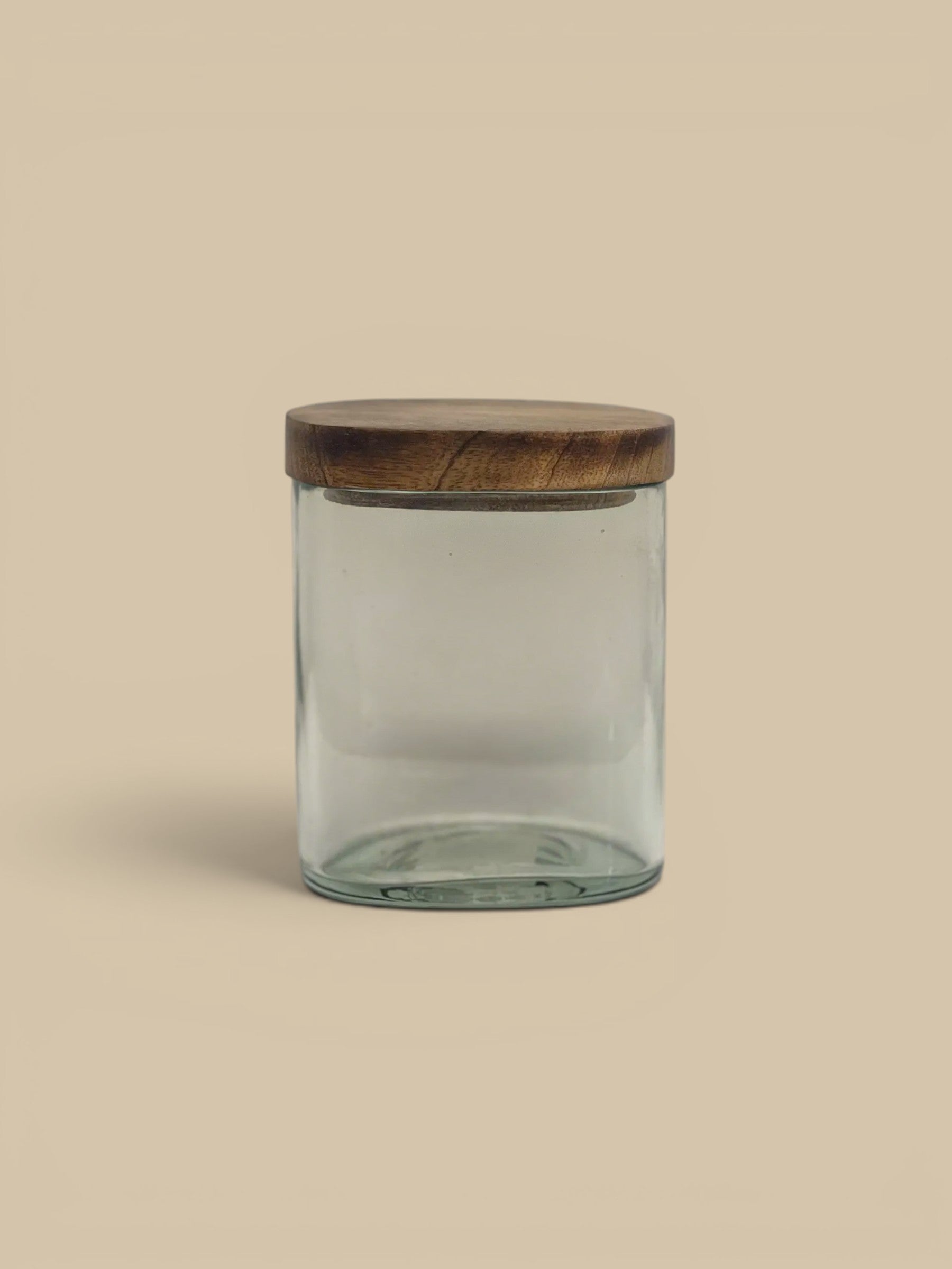 Homestyle Collective clear glass storage jar with a natural wood lid, perfect for pantry or countertop organization.