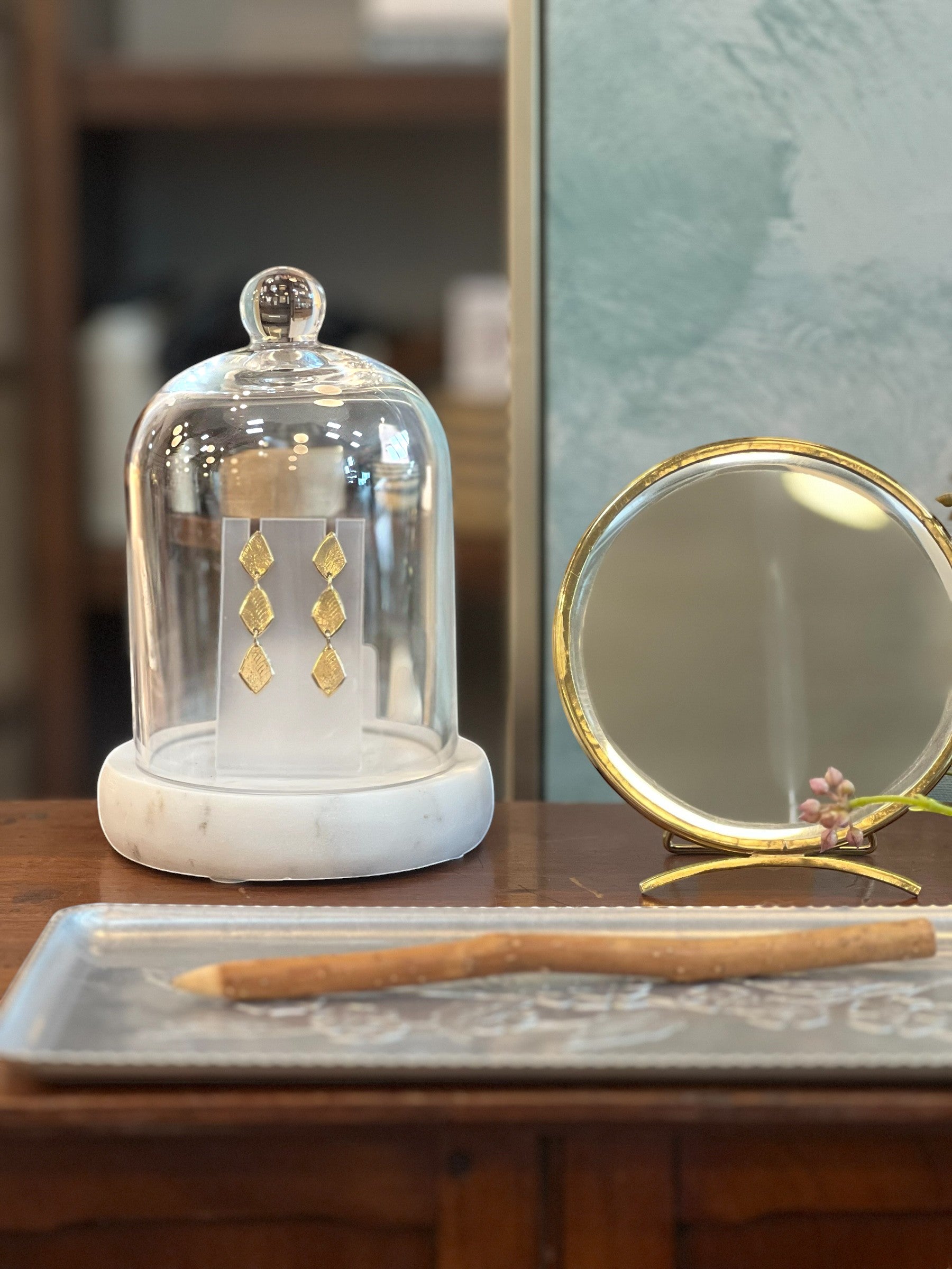 Homestyle Collective golden arc folding mirror with brass frame and adjustable base, perfect for vanities and desks.