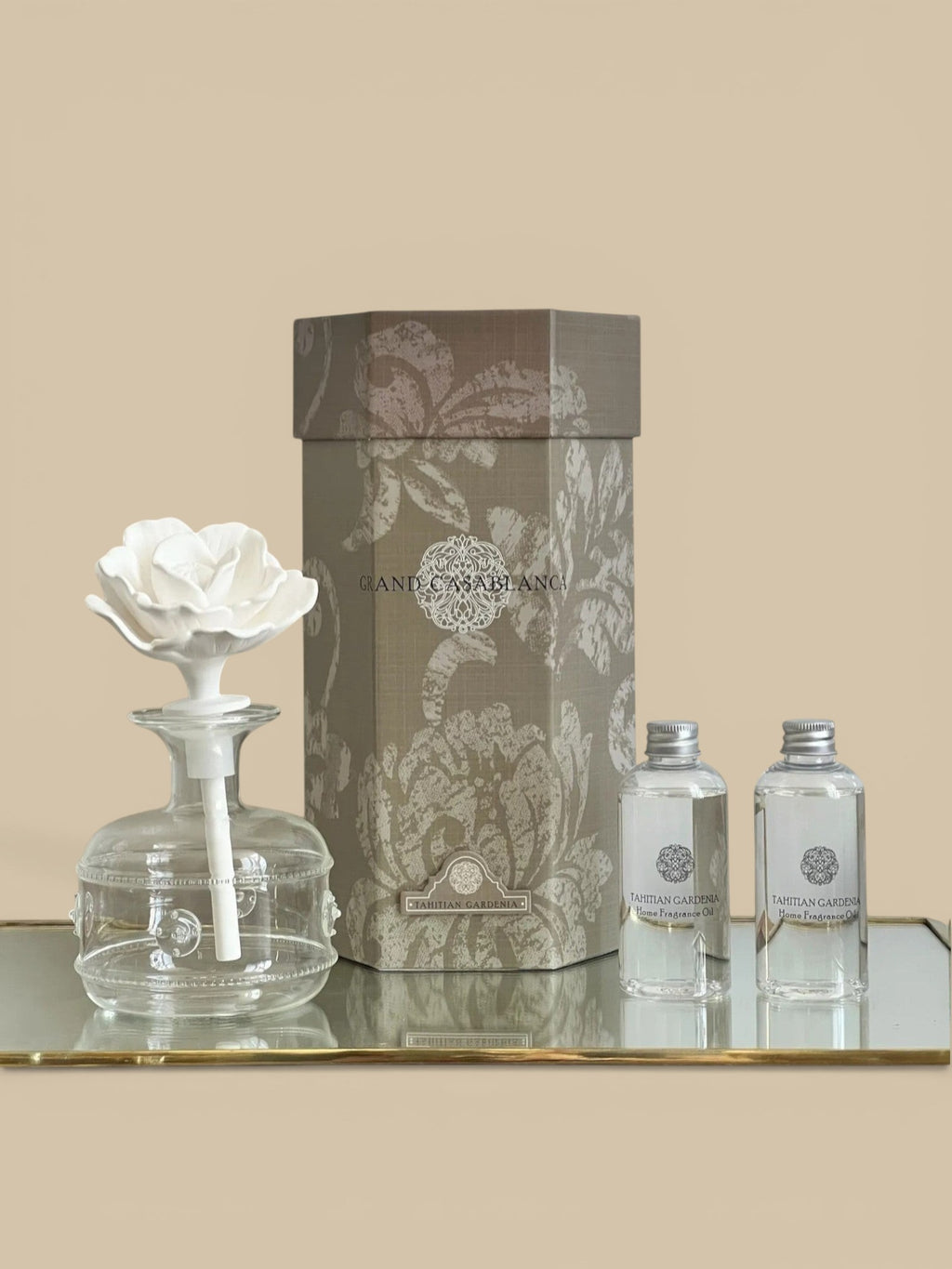 Homestyle Collective Grand Casablanca Tahitian Gardenia porcelain diffuser with white flower and glass bottle.