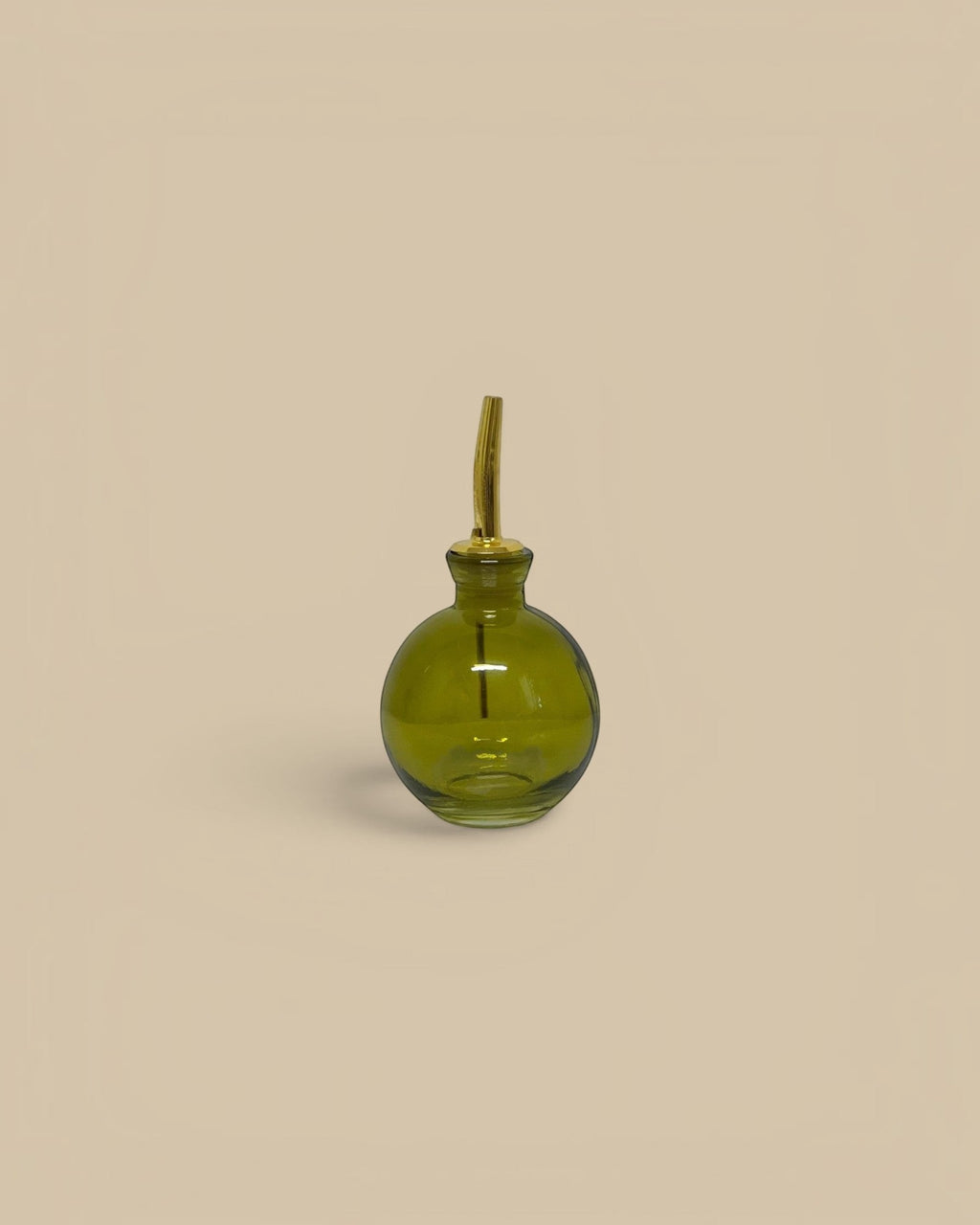 Homestyle Collective round green glass oil cruet with gold pour spout, 4 oz capacity.
