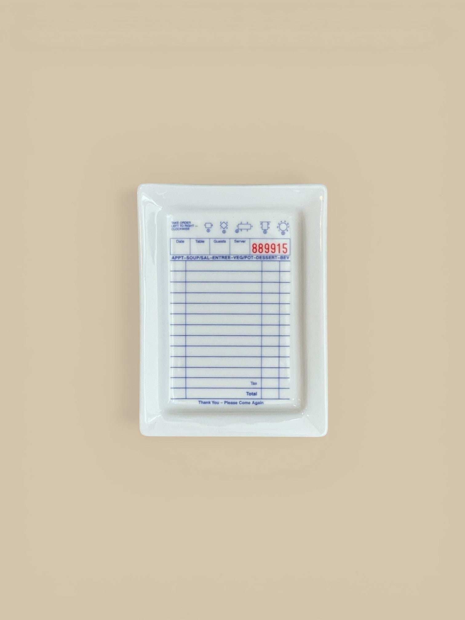 Homestyle Collective white ceramic tray designed like a guest check with blue lines and text.