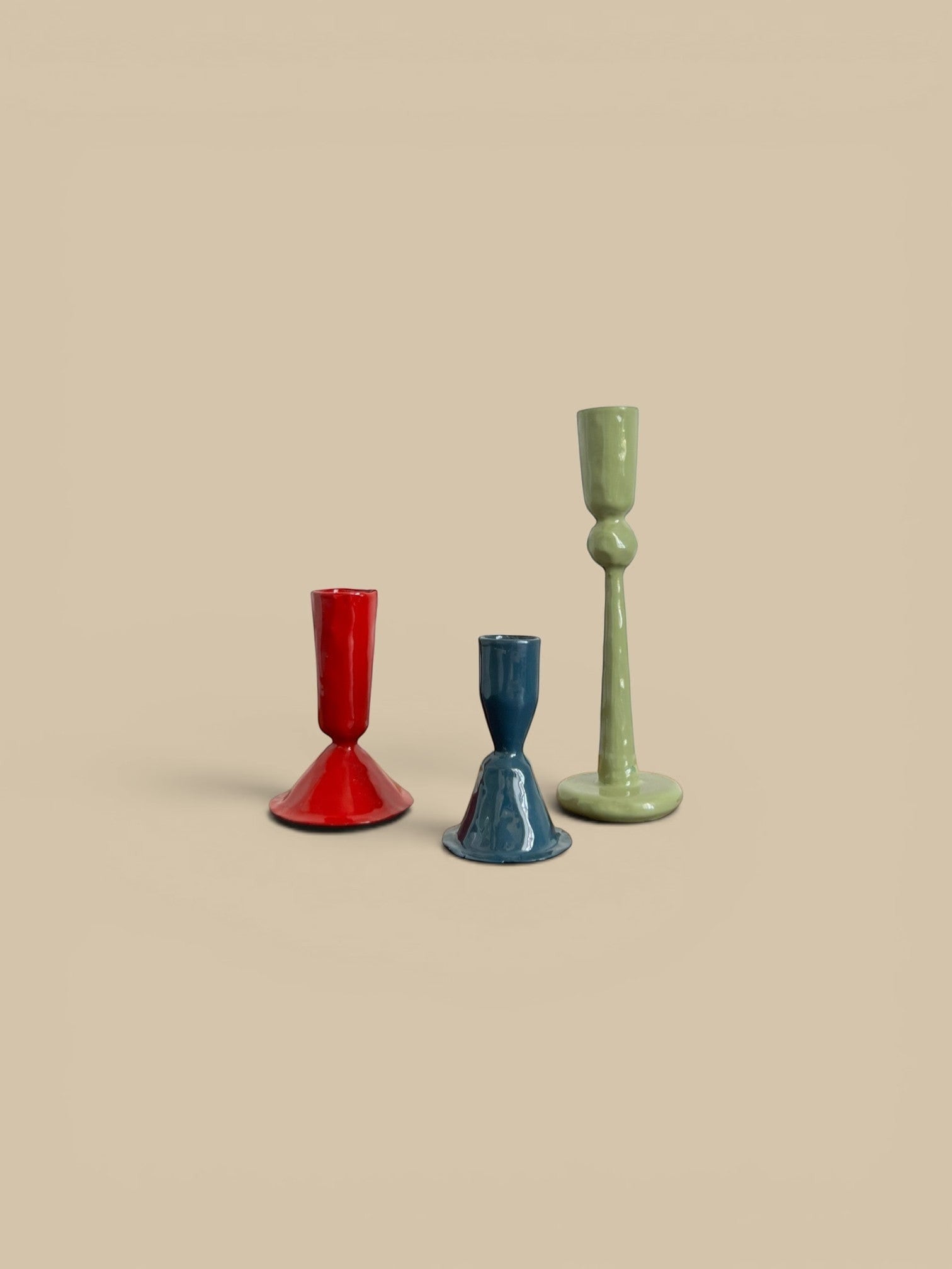 Homestyle Collective hand-forged candlestick holders in red, blue, and green. Available in 3 sizes.