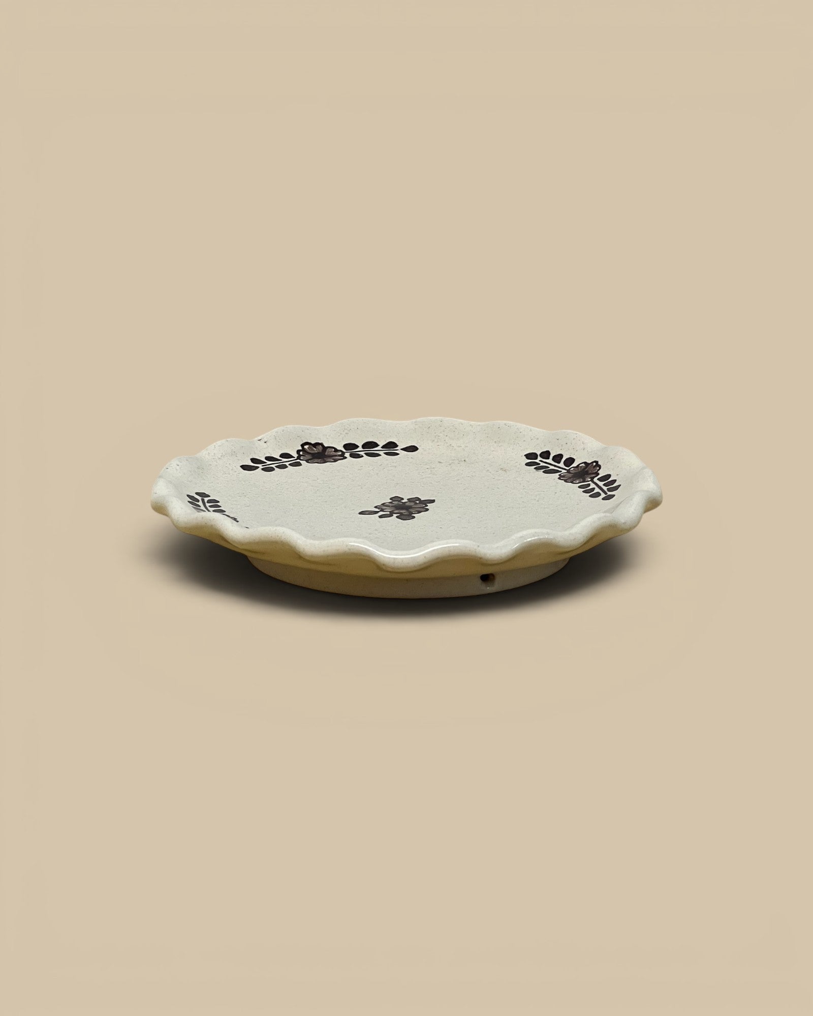 Homestyle Collective hand-painted ceramic dessert plate with scalloped edges and floral motifs in dark brown.