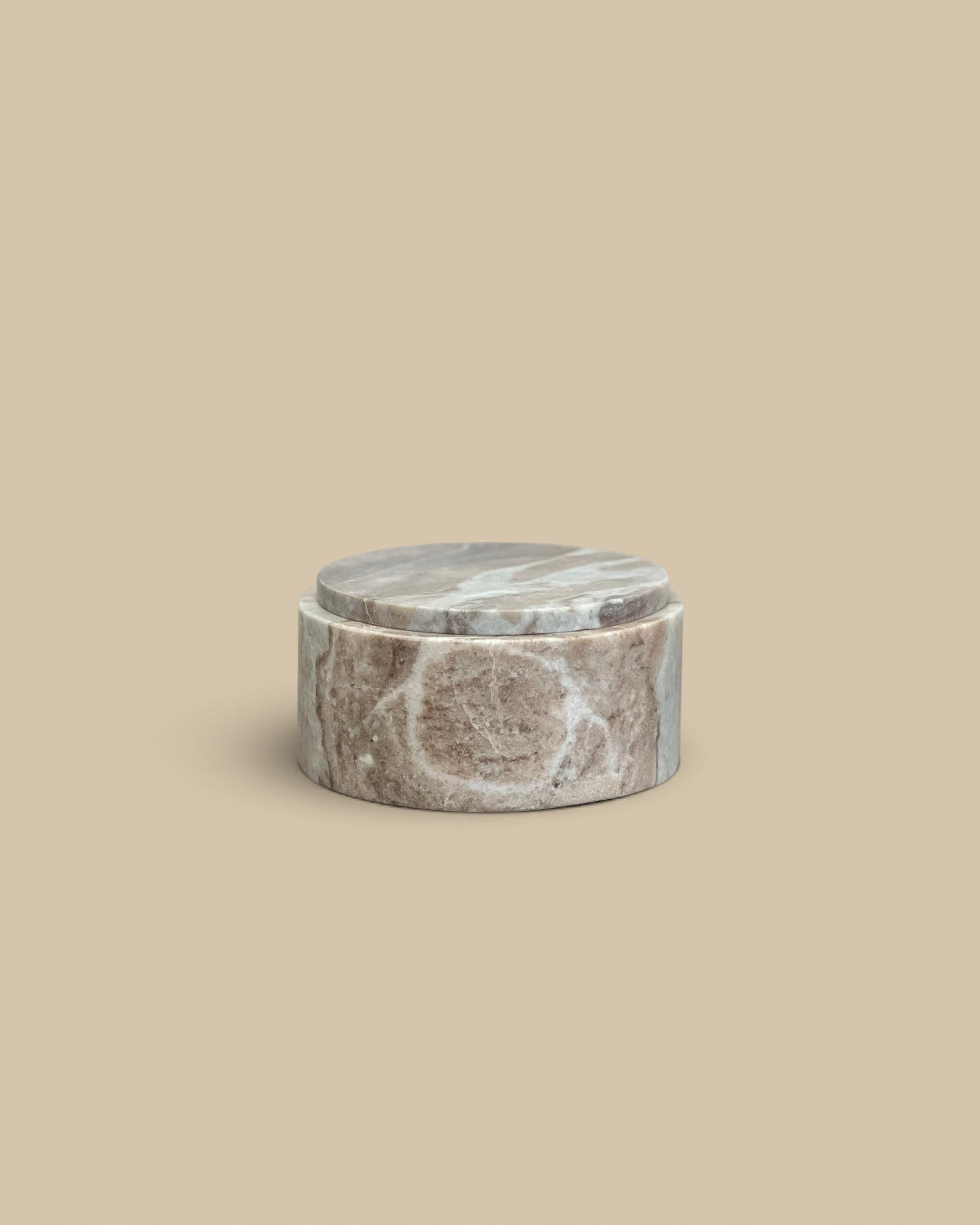 Homestyle Collective Jacqueline round lidded box in brown veined marble with a semi-matte finish.