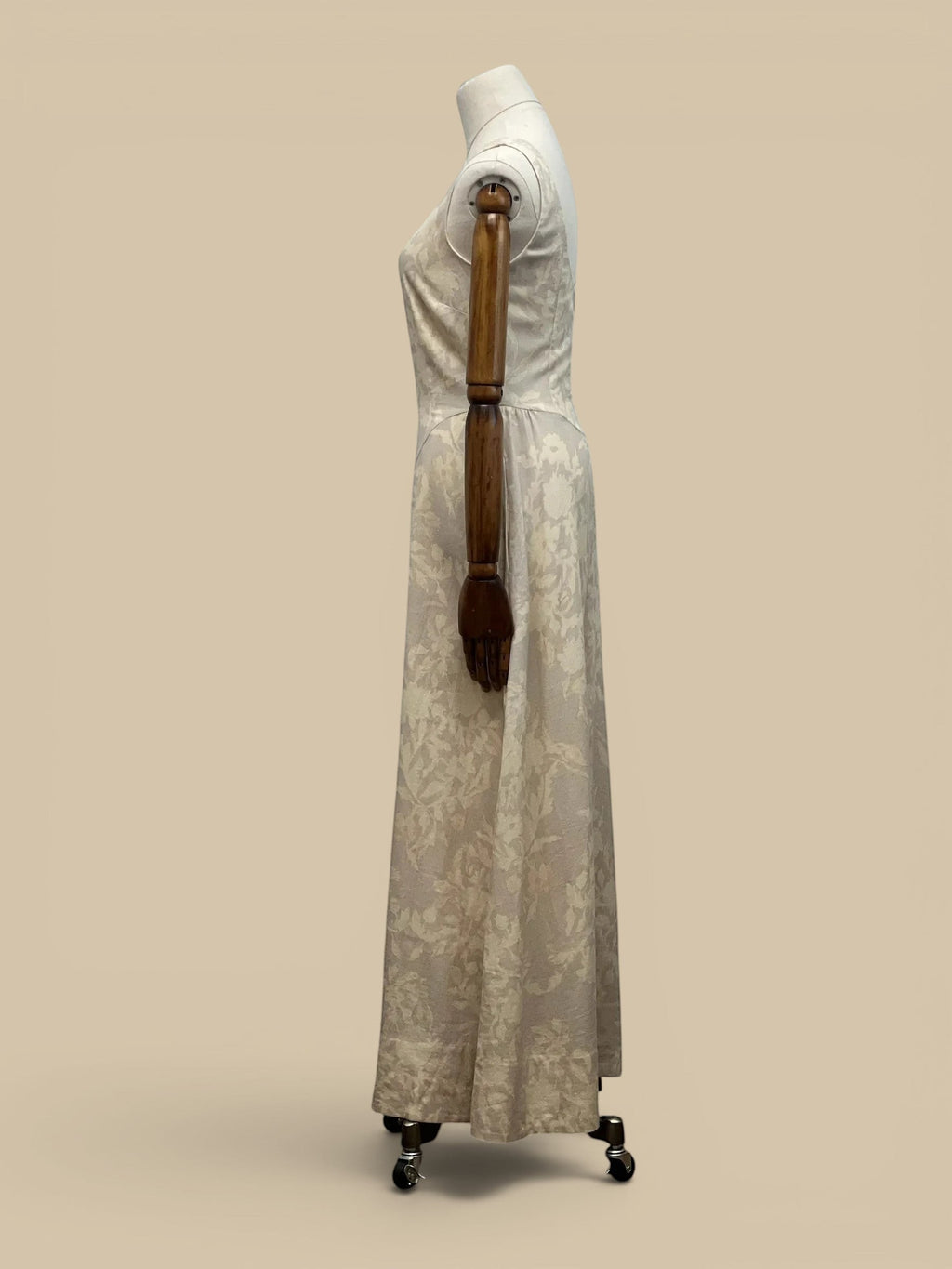 Homestyle Collective linen Parker dress in cream with a subtle floral pattern, shown from a side profile view.