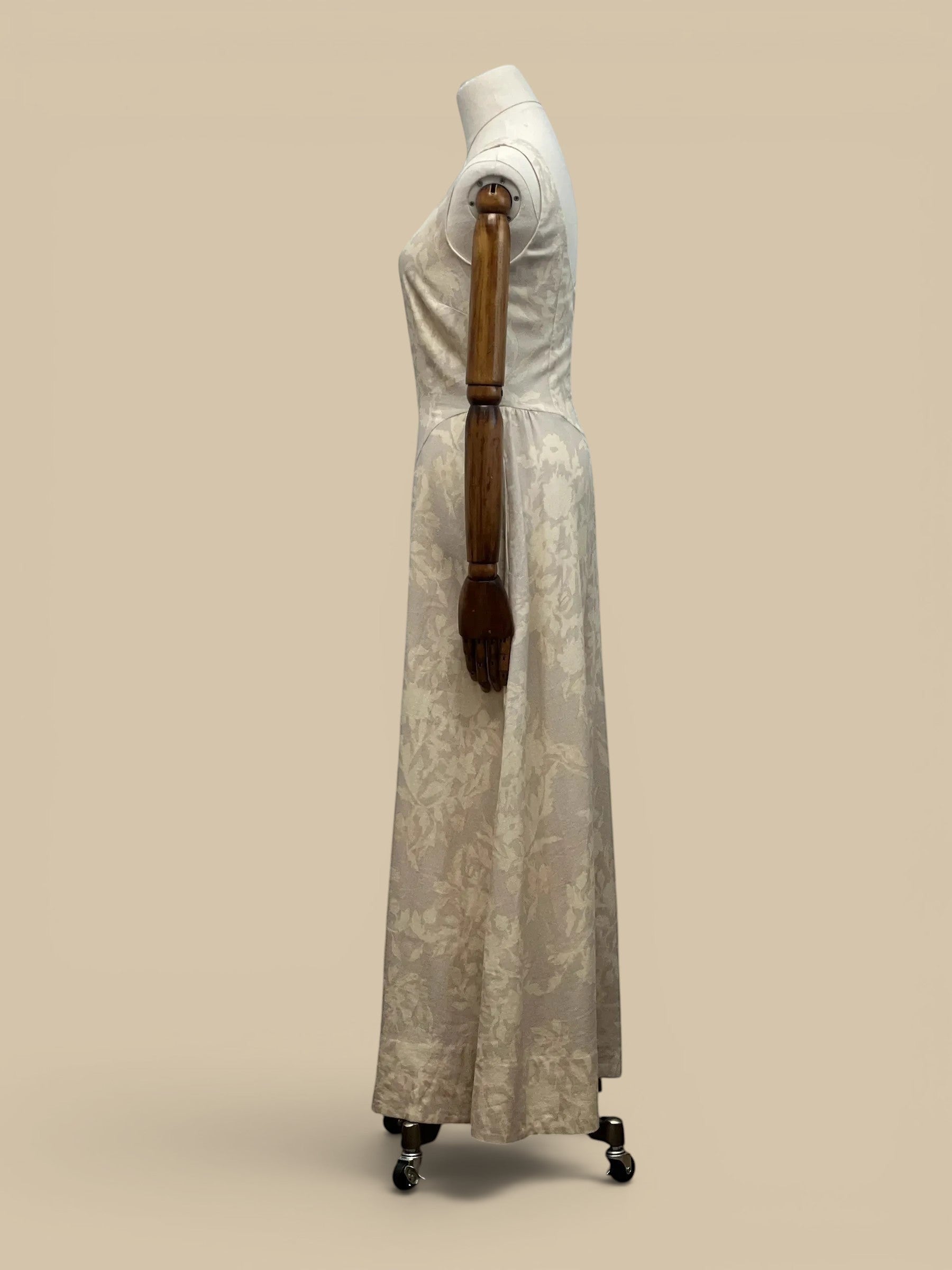 Homestyle Collective linen Parker dress in cream with a subtle floral pattern, shown from a side profile view.