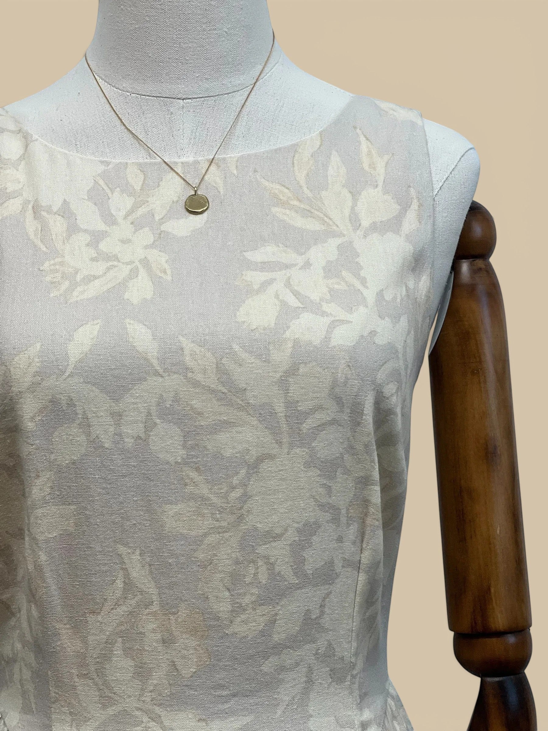 Homestyle Collective beige linen Parker dress featuring a subtle tone-on-tone floral pattern on a sleeveless bodice.