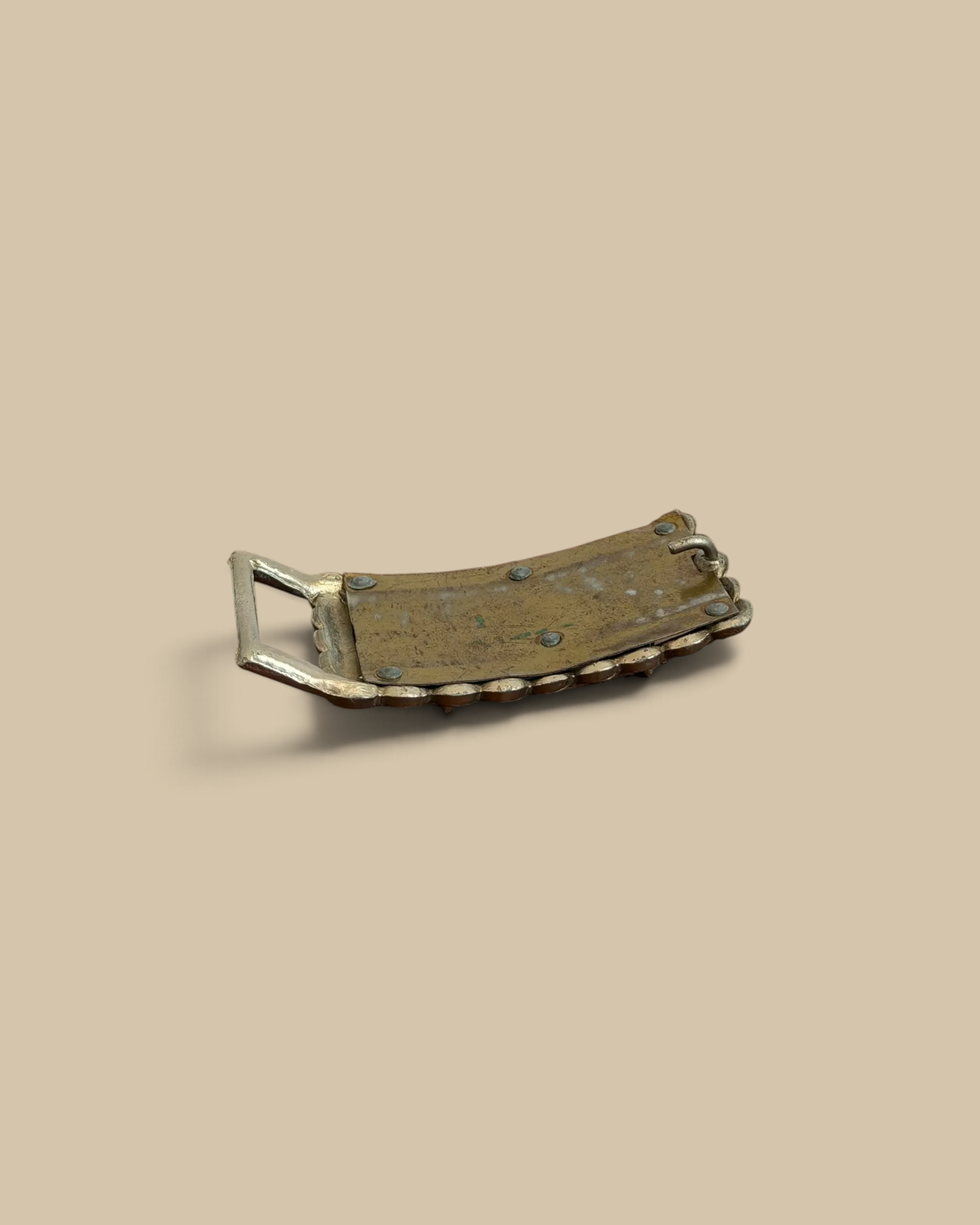 Homestyle Collective Found Cast Longhorn Belt Buckle made of cast iron with a resin inlay on a wooden surface.
