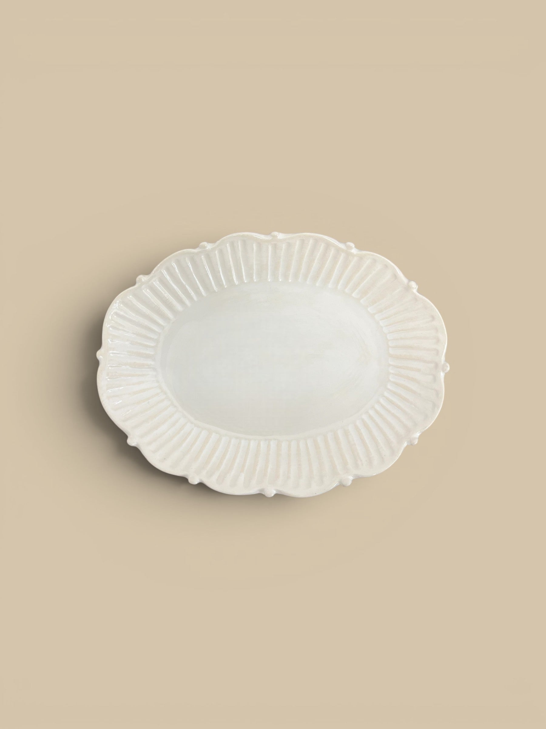 Homestyle Collective Mabel oval serving tray in cream ceramic with beaded edge detail and fluted sides.
