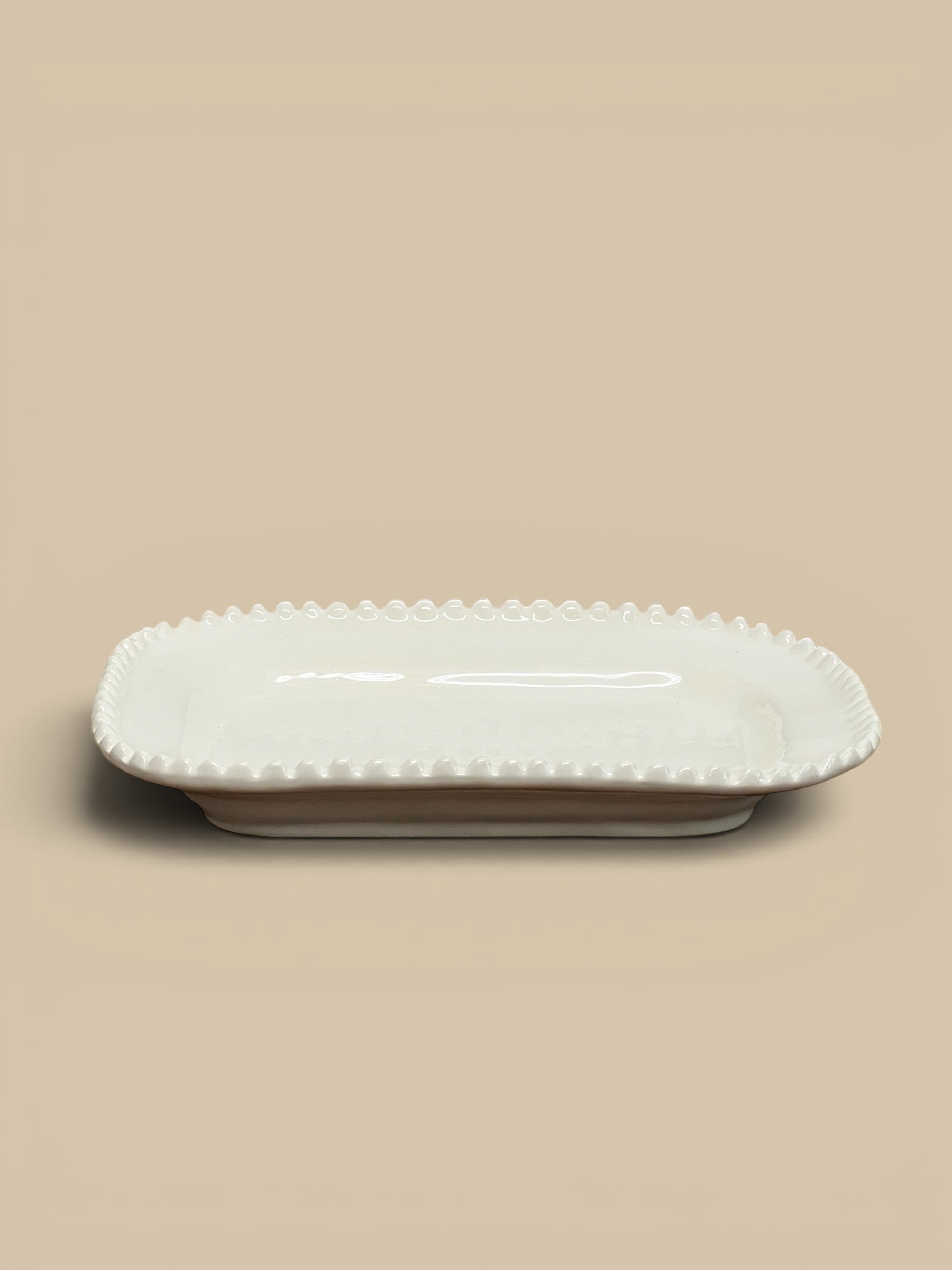 Homestyle Collective Mabel rectangular ceramic serving tray with beaded edge detail, glossy finish, neutral cream color.