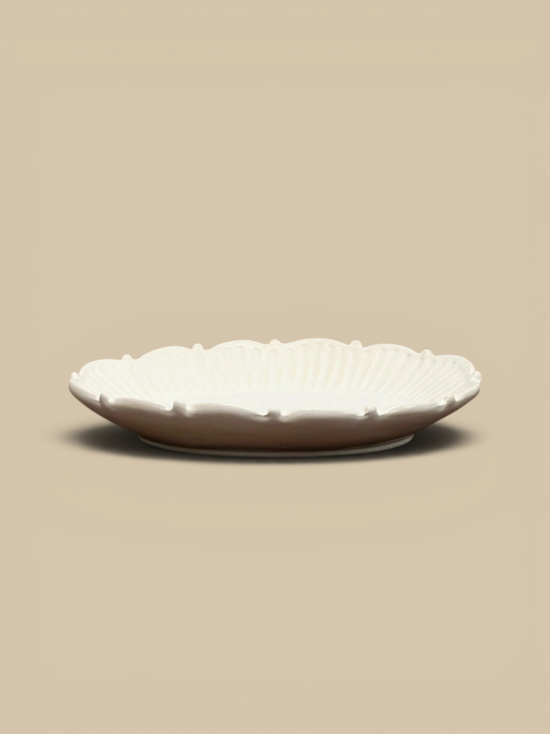 Homestyle Collective Mabel white ceramic serving tray with beaded edge detail and fluted interior, perfect for appetizers or decor.