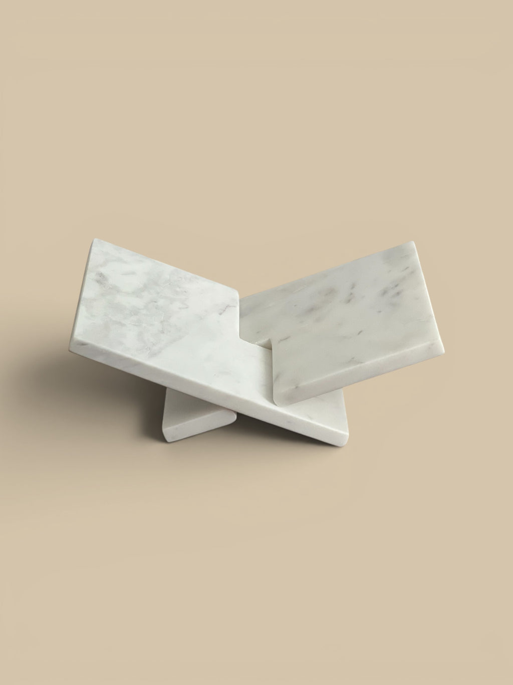 Homestyle Collective interlocking white marble book display stand with grey veining.