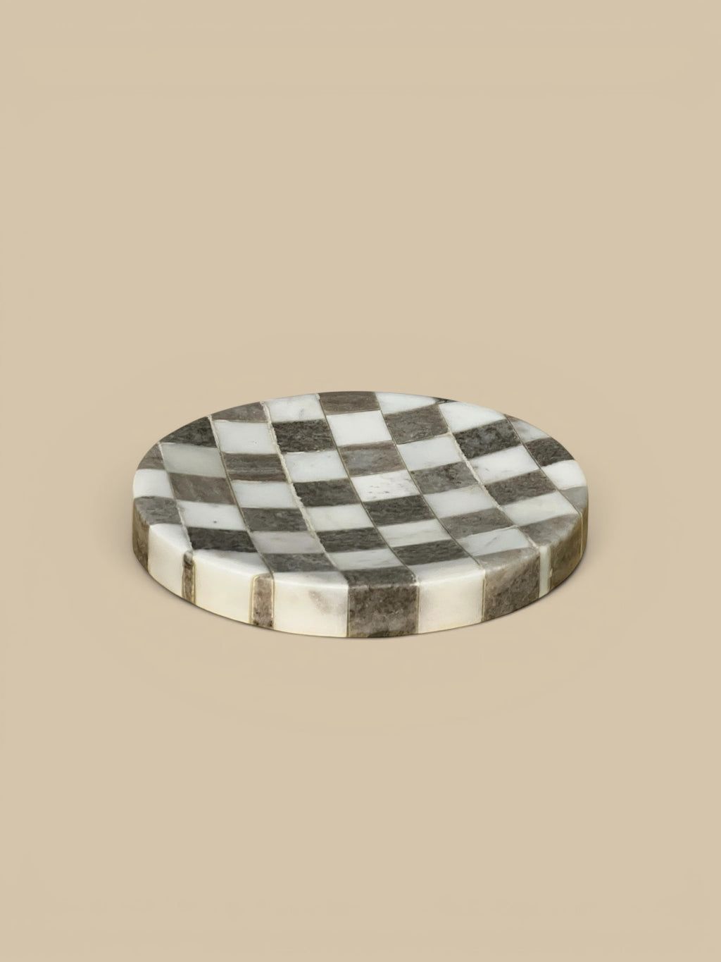 Homestyle Collective round marble serving tray with a black and white checkered pattern.