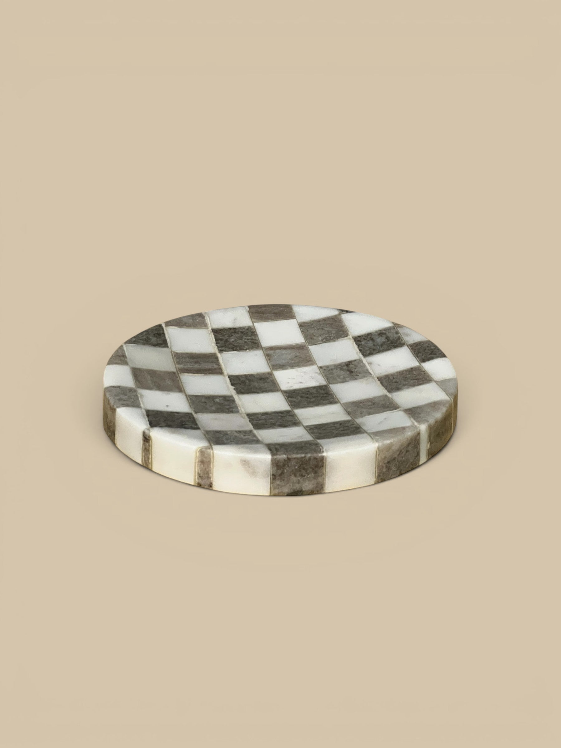 Homestyle Collective round marble serving tray with a black and white checkered pattern.