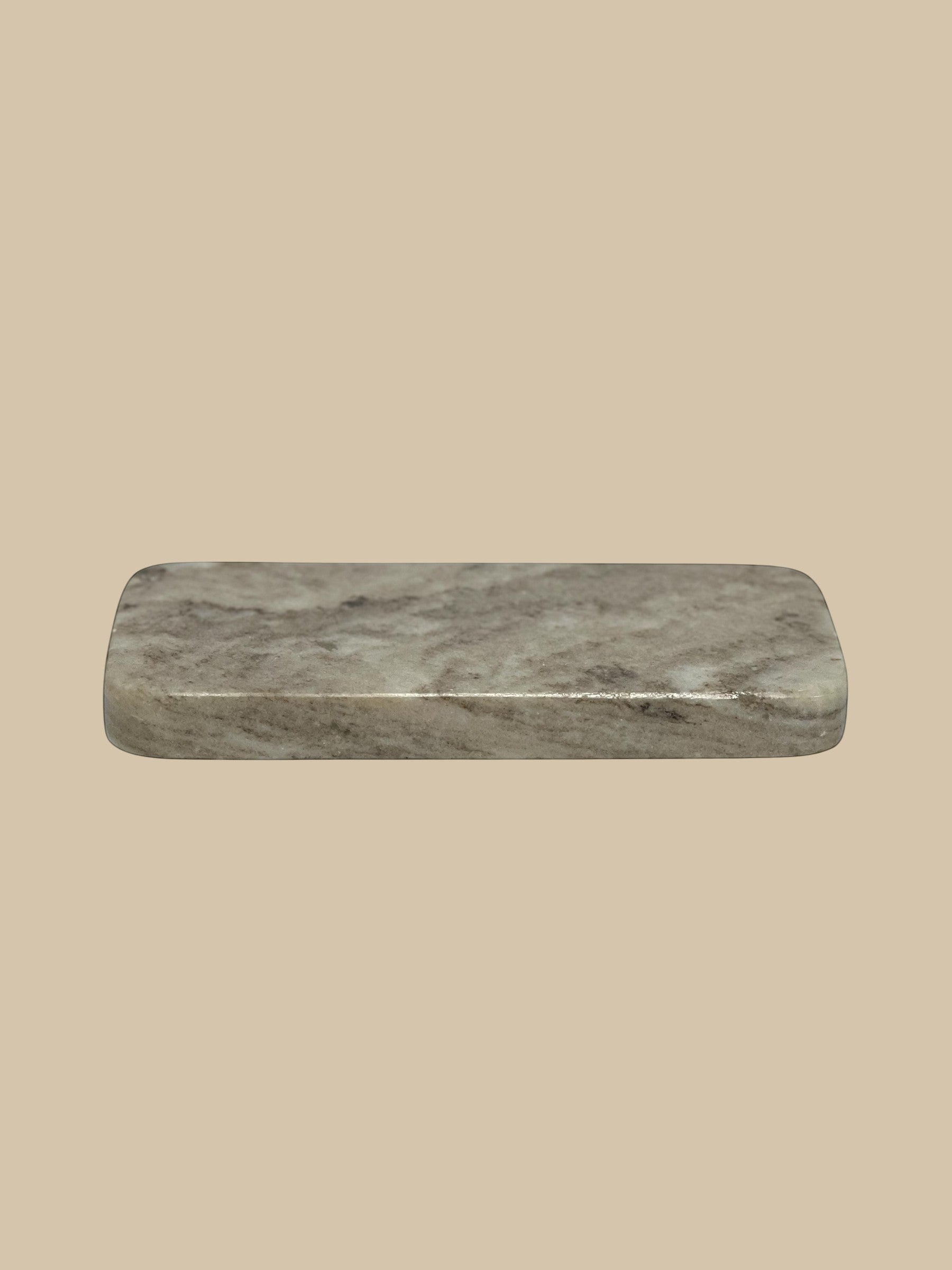 Homestyle Collective rectangular marble serving board with grey veining, 10" L x 4" W x 1" H.