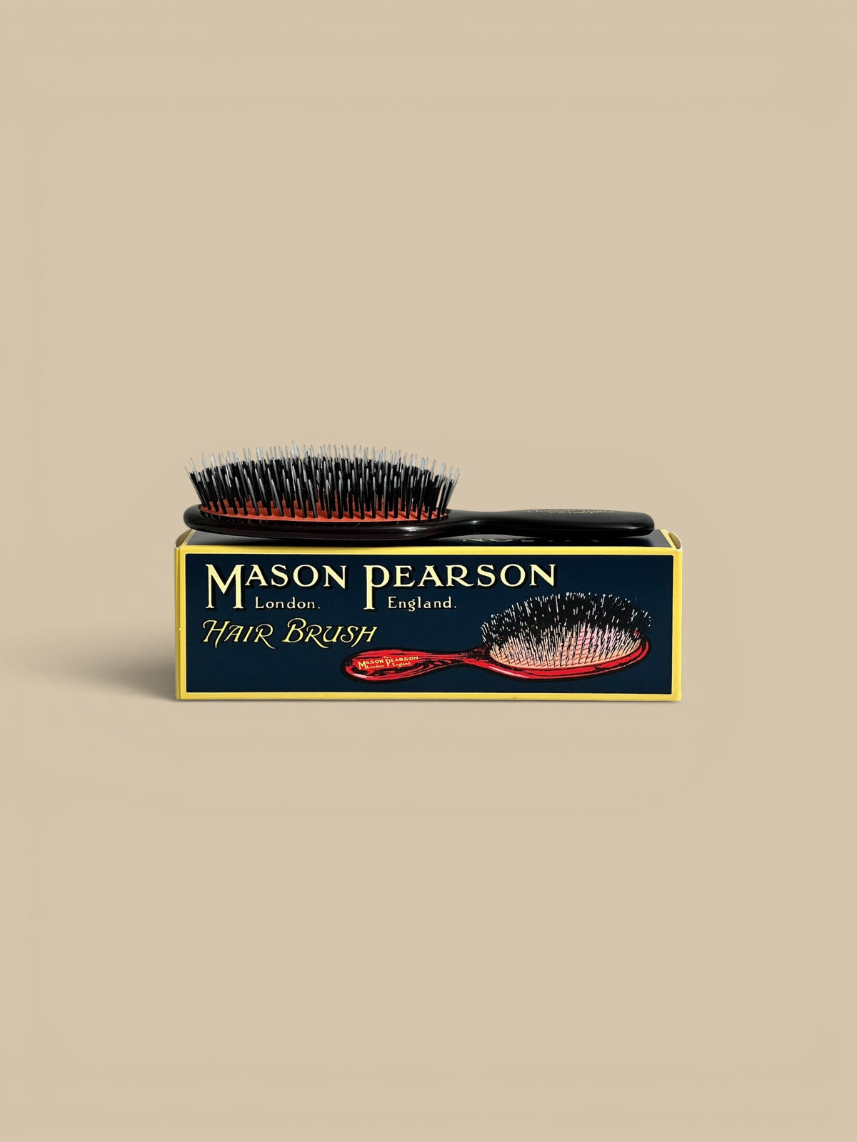 Homestyle Collective Mason Pearson Dark Ruby Pocket Brush with boar bristles and nylon pins on dark ruby handle.