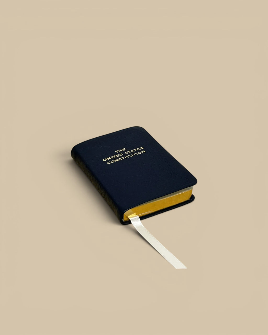 Homestyle Collective mini United States Constitution book in navy leather with gold lettering and gilt page edges.