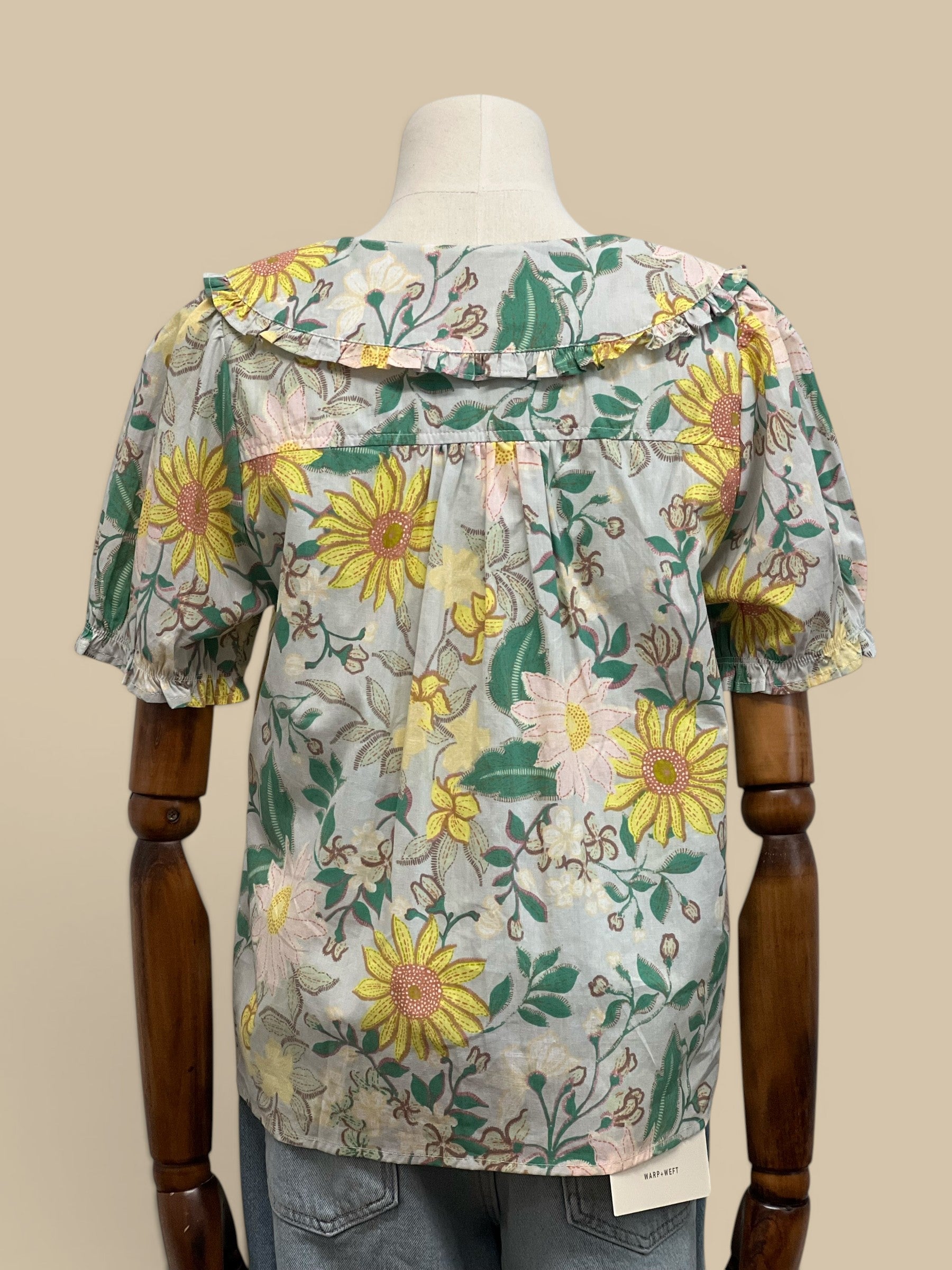 Homestyle Collective mint floral print short sleeve blouse with doll collar and ruffled cuffs.