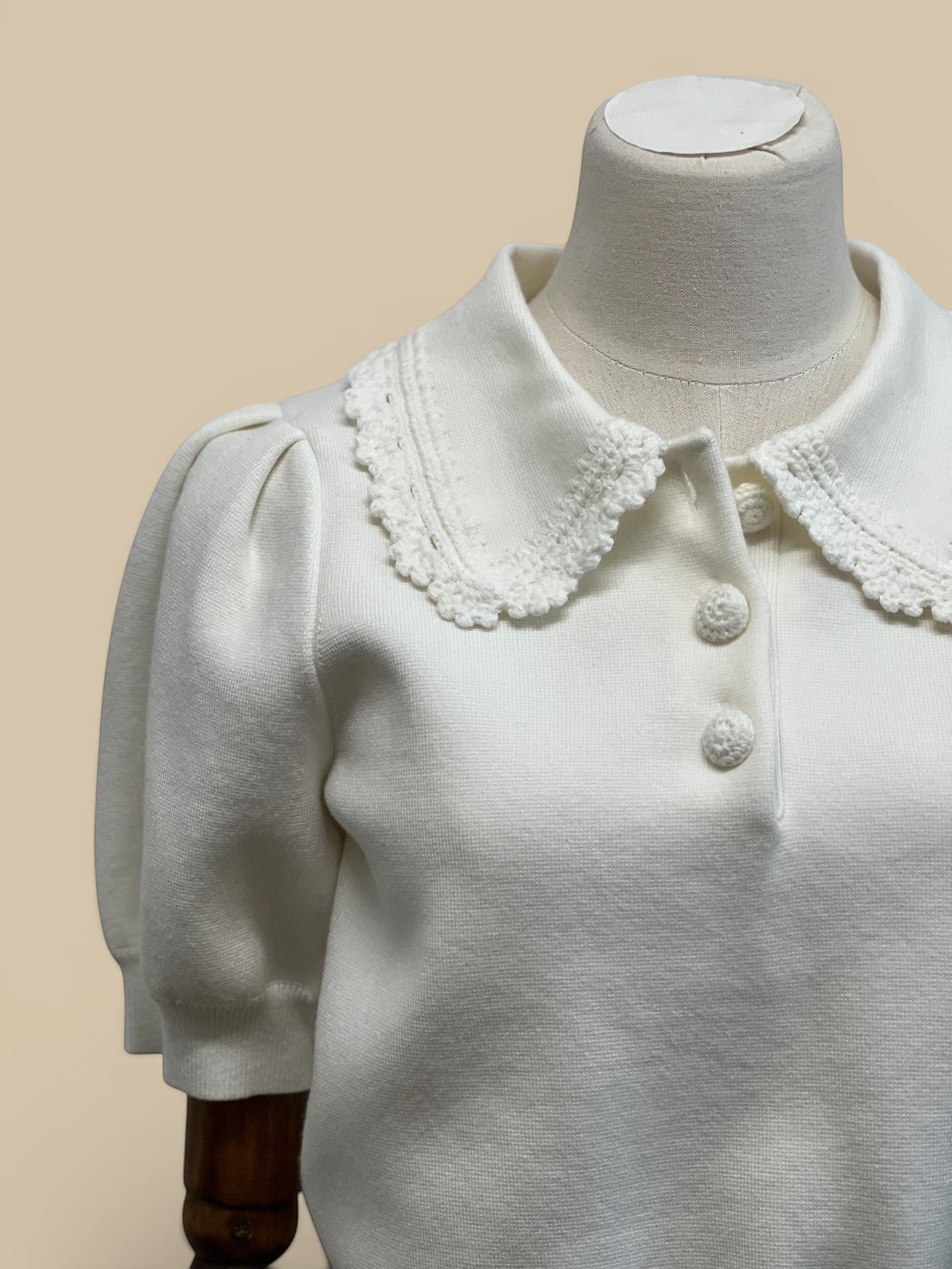 Homestyle Collective off-white knit top with scallop collar, short puff sleeves, and button detail.