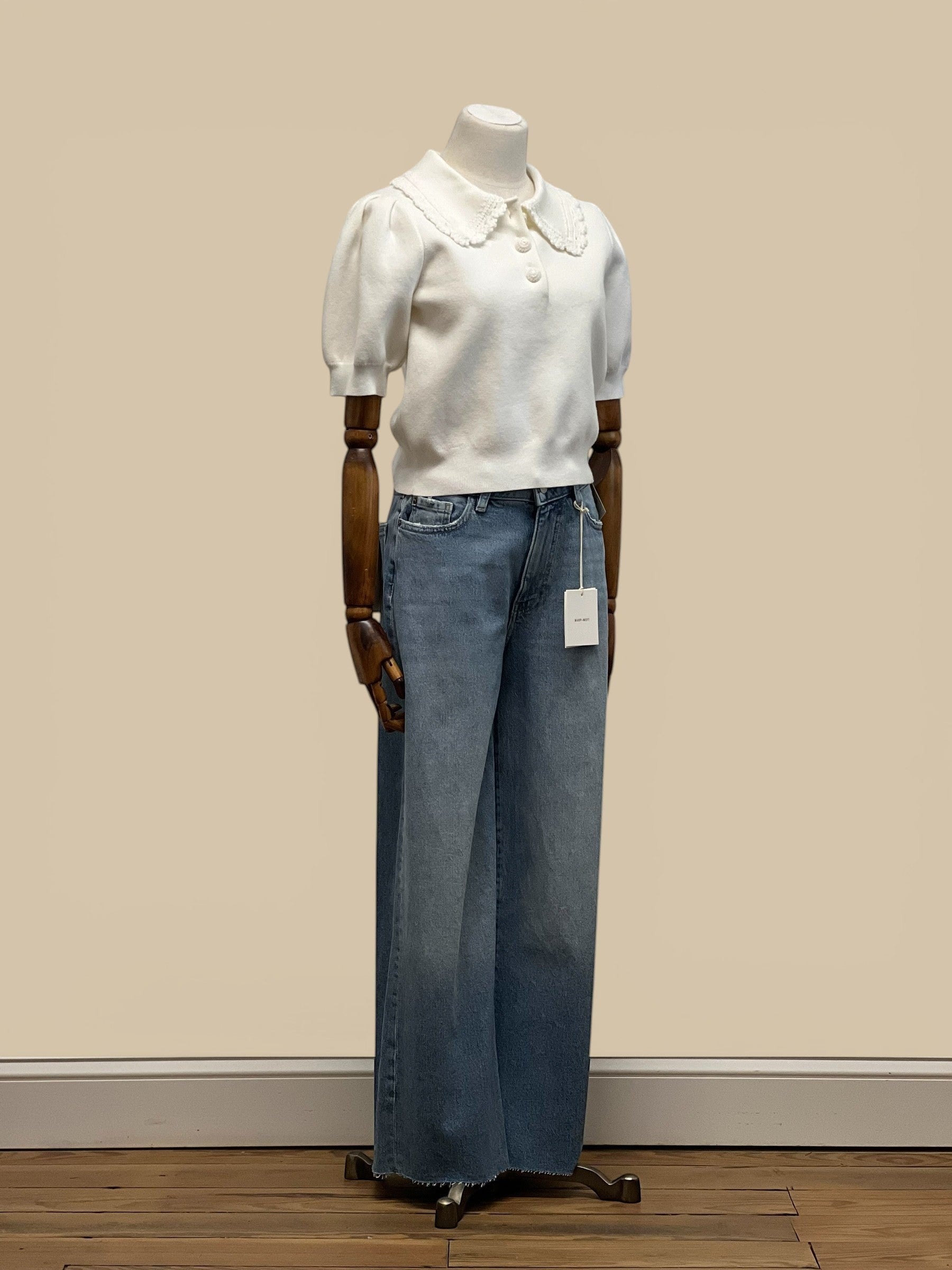 Homestyle Collective off-white knit top with scallop collar and short puff sleeves, button front, paired with wide-leg jeans.