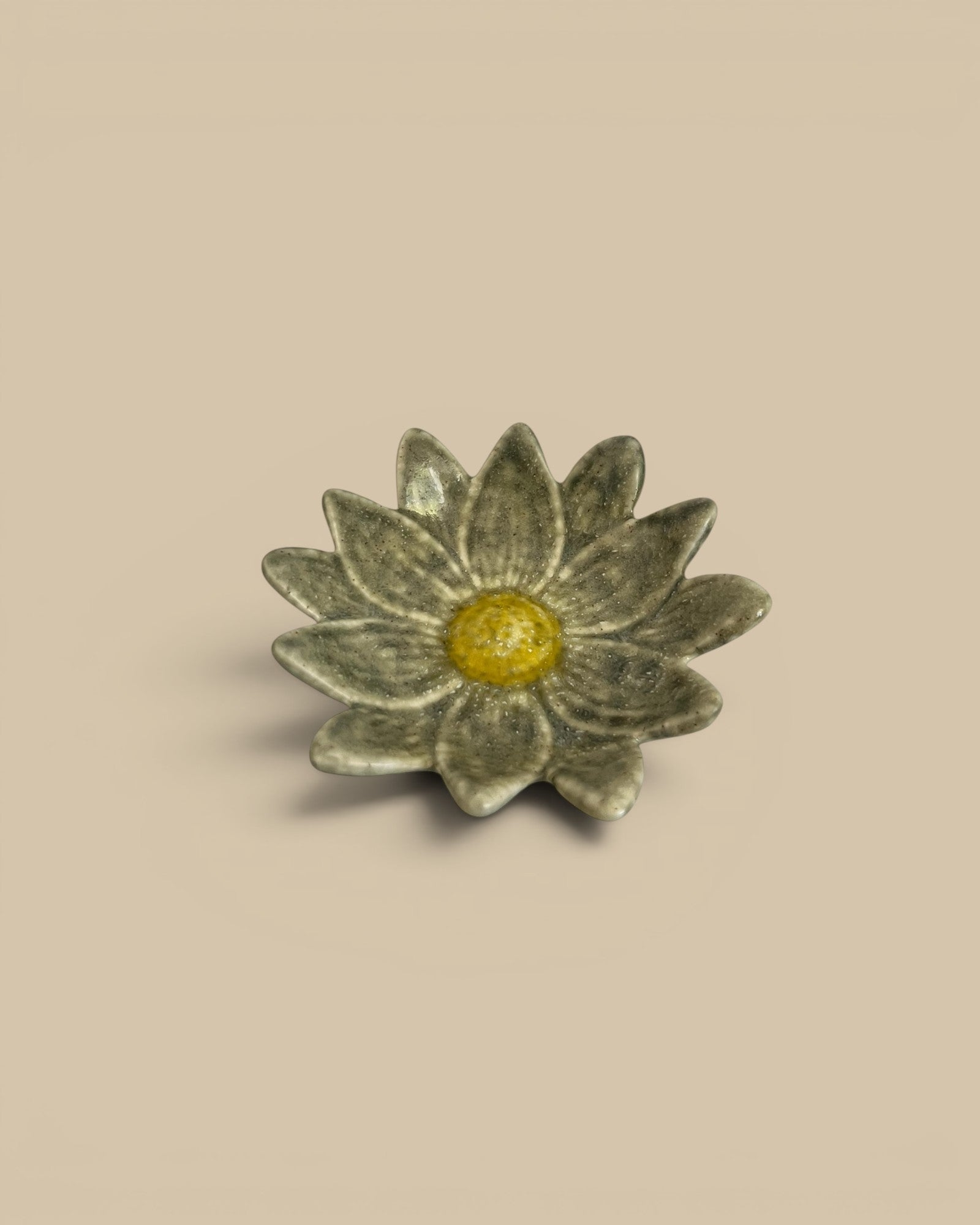 Homestyle Collective stoneware flower-shaped dish with yellow center and grey petals, 4.5" round.