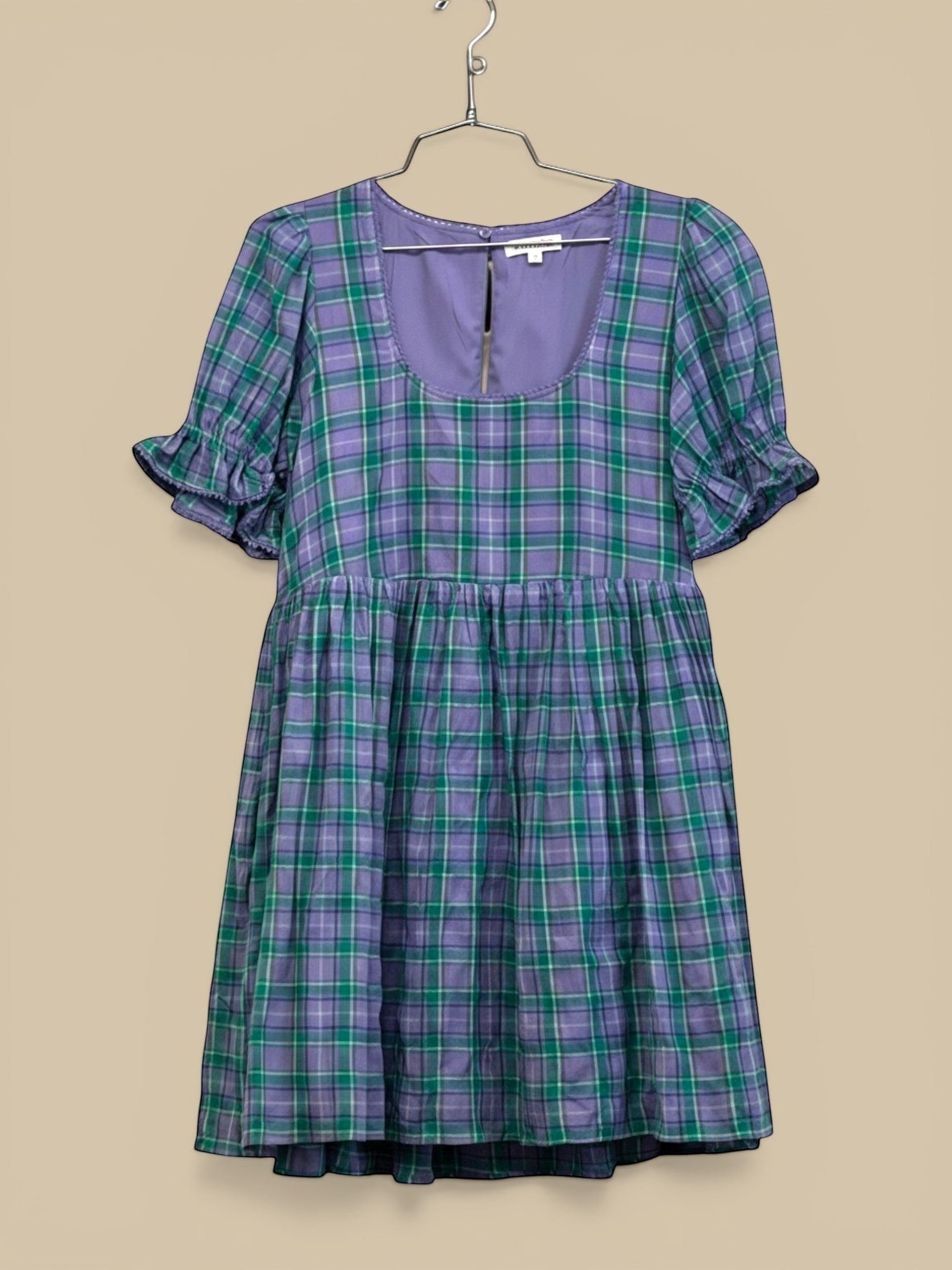 Homestyle Collective lavender and green plaid flannel babydoll mini dress with square neckline and ruffle trim.