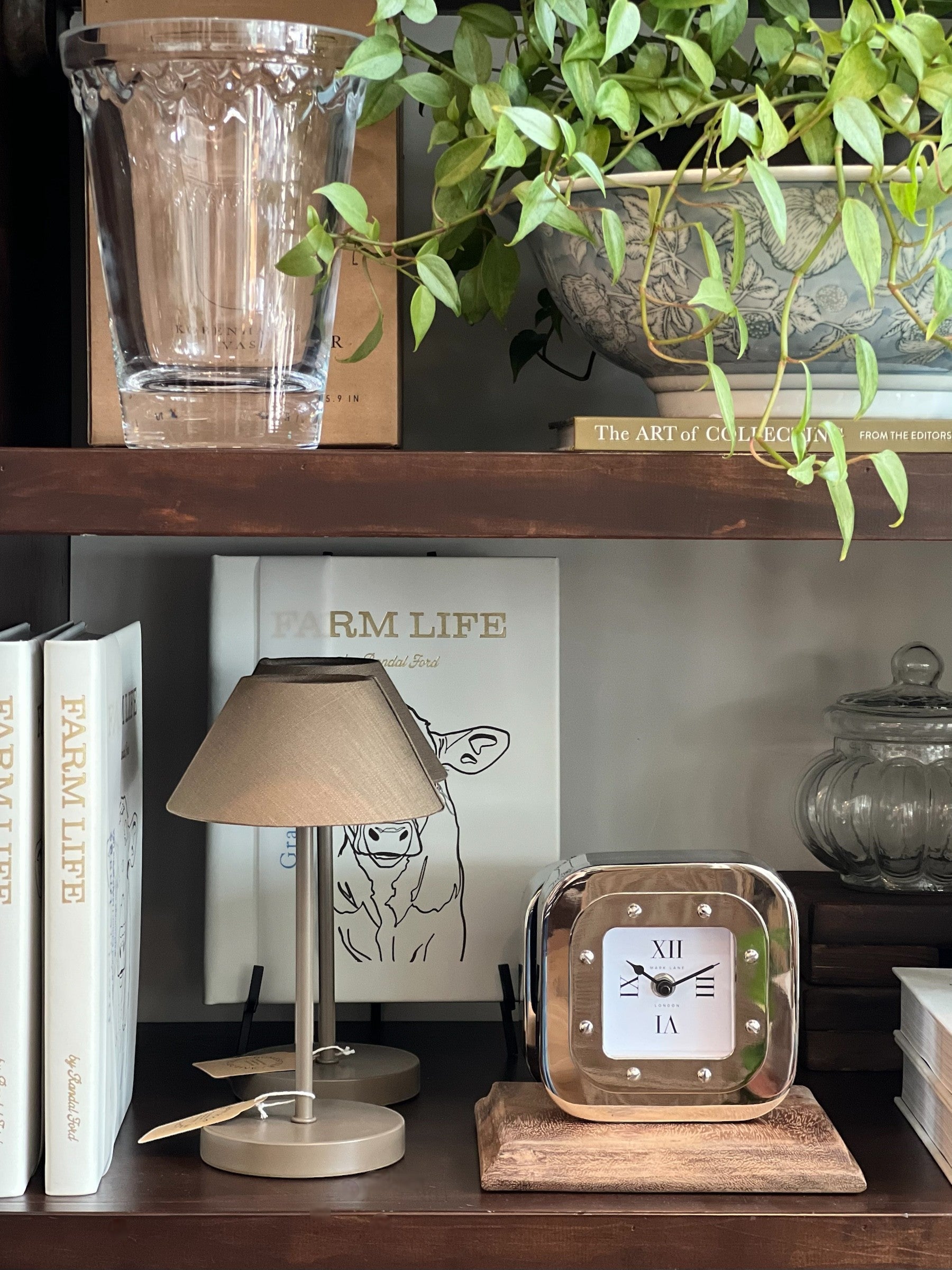 Homestyle Collective polished nickel square table clock with Roman numerals and a white face, set on a wooden base.