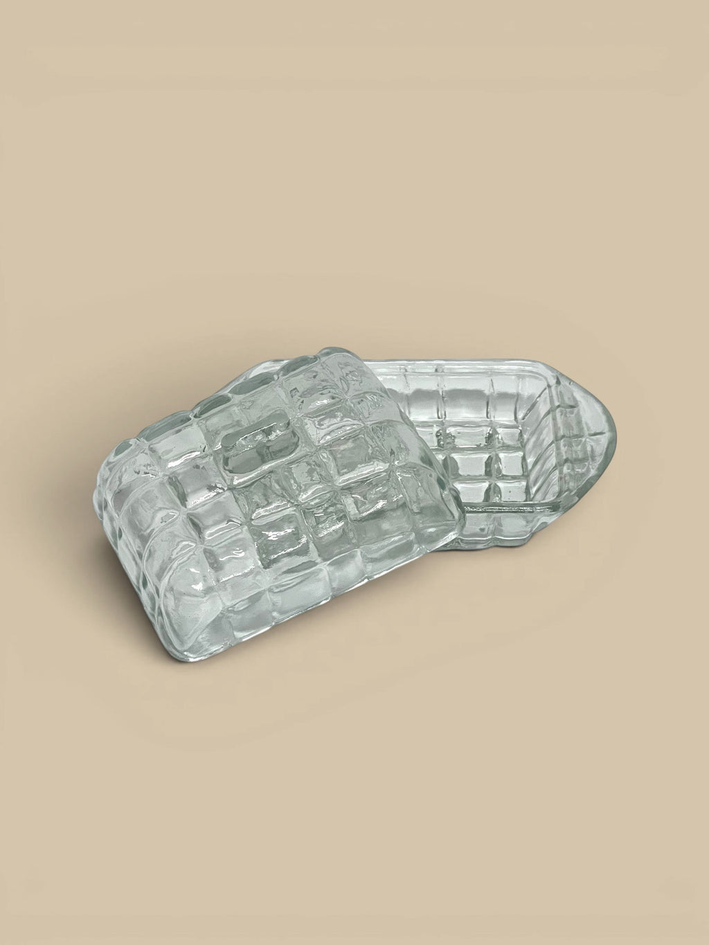 Homestyle Collective clear pressed glass butter dish with textured grid pattern and lid.