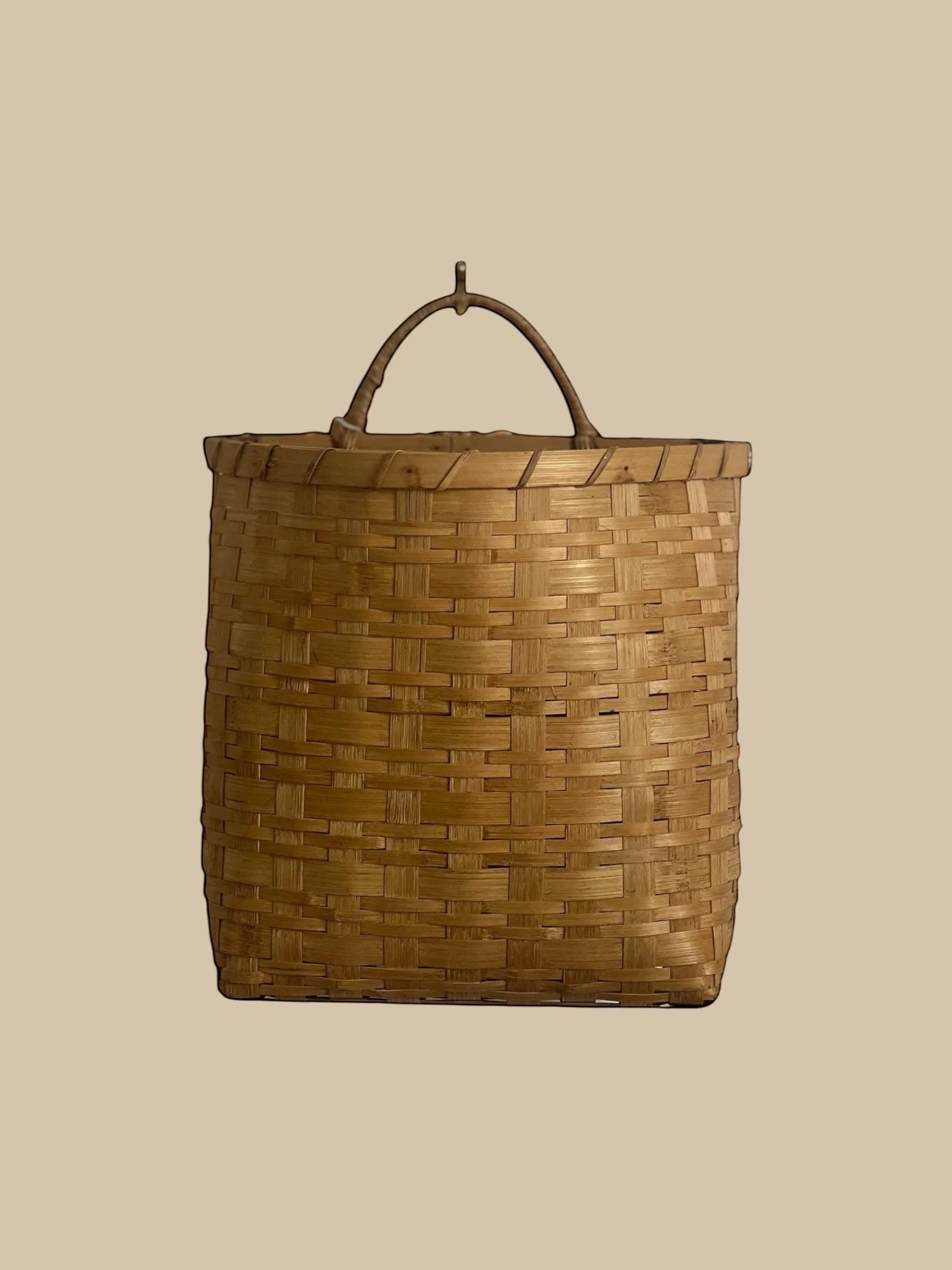 Homestyle Collective natural rattan hanging basket with handle, flat back, woven texture. Set of 2.