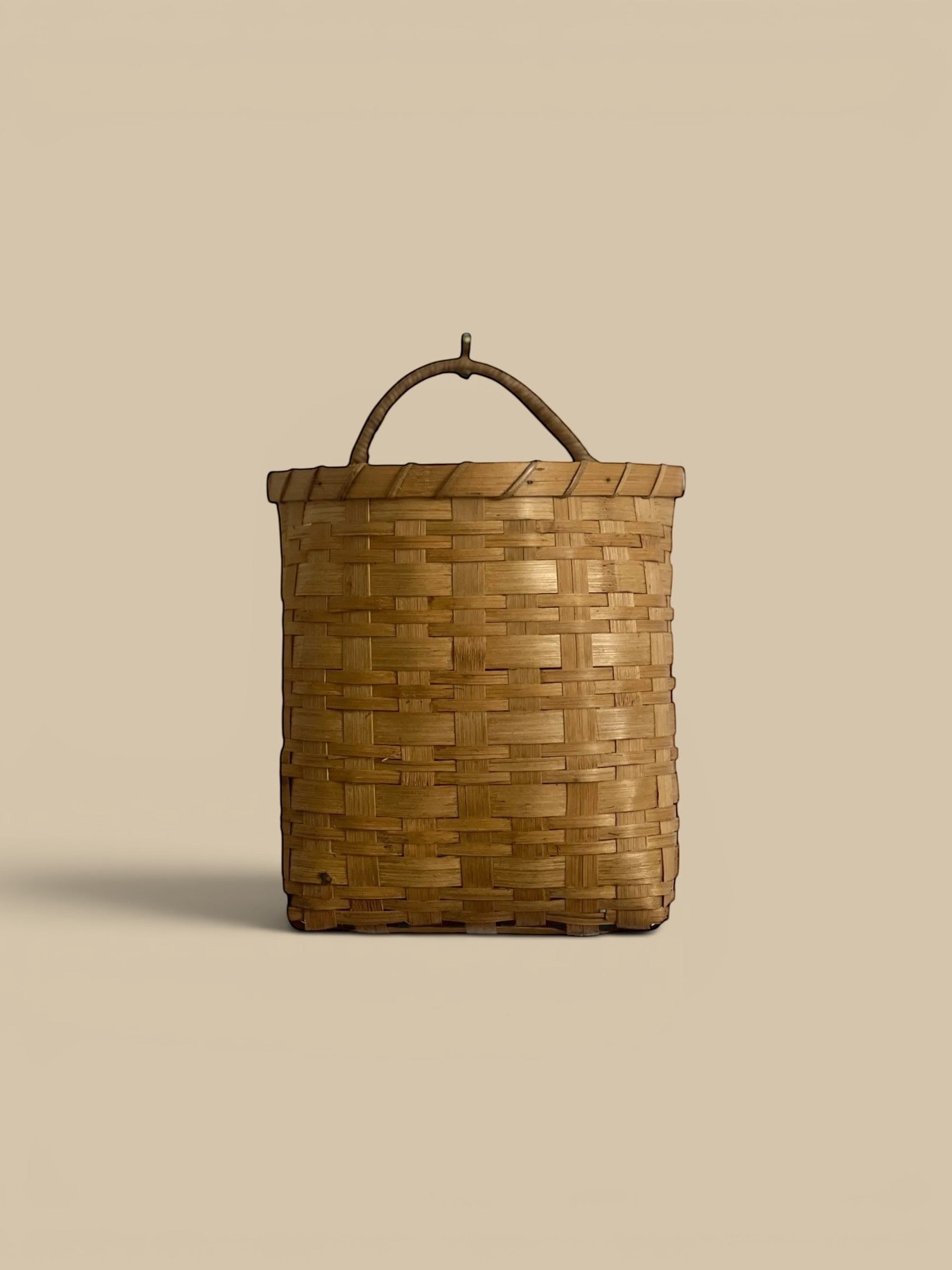 Homestyle Collective natural rattan hanging basket with handle, flat back, woven texture. Set of 2.
