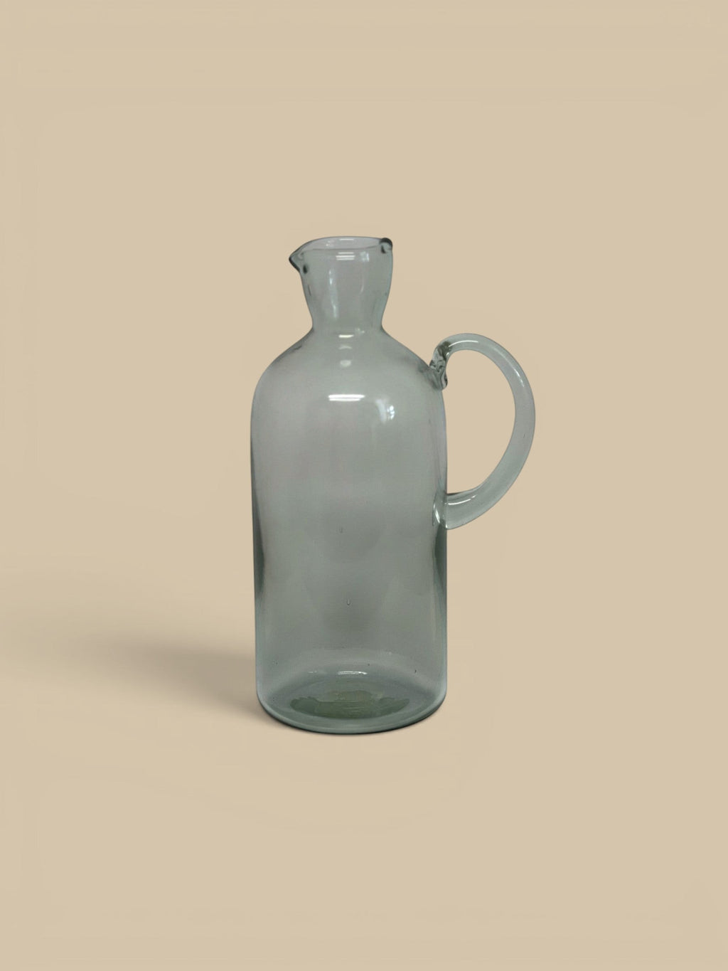 Homestyle Collective Santiago recycled glass carafe with handle and spout, clear grey.