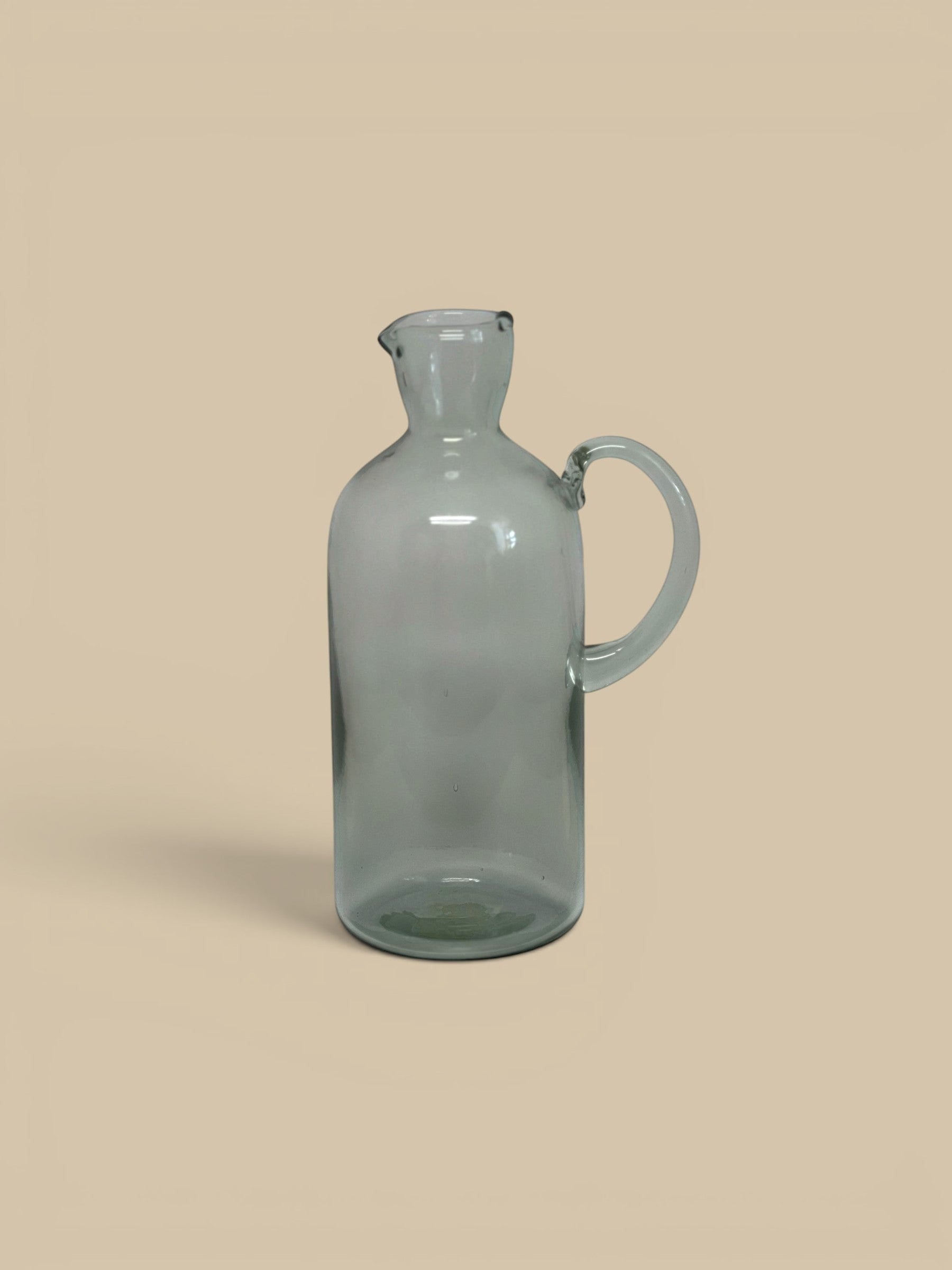 Homestyle Collective Santiago recycled glass carafe with handle and spout, clear grey.