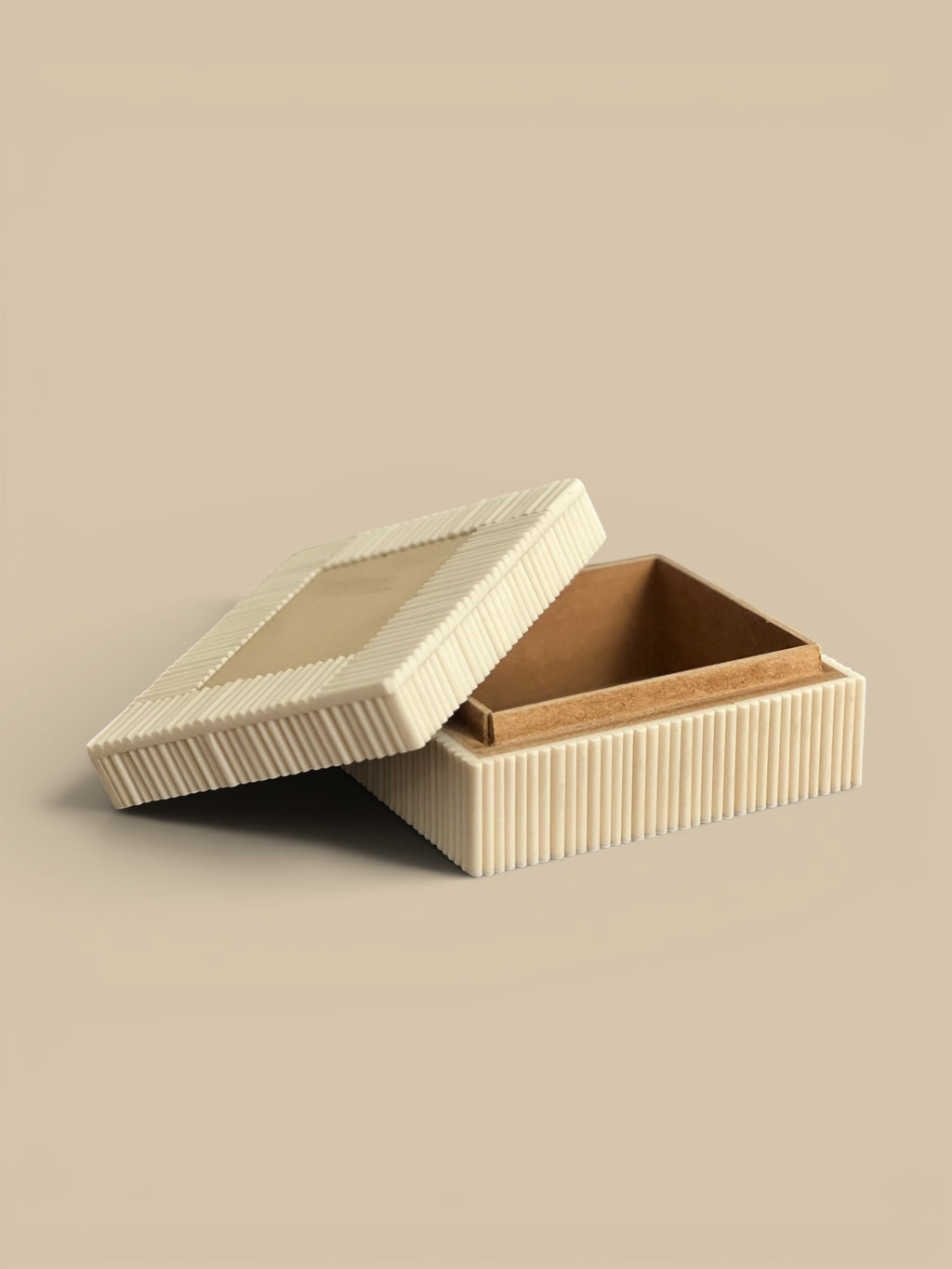 Homestyle Collective ivory bone accent box with ribbed exterior and smooth lid, open to show interior.